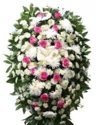 Hearts of Remembrance Standing Spray - A graceful and elegant standing spray featuring a classic white and red color palette. This heartfelt tribute is arranged with all-white cushion mums and white spider mums, accented with vivid red roses and fresh greenery for a full and balanced display.  Symbolizing love, purity, and remembrance, this arrangement offers a dignified and comforting tribute, perfect for funeral or memorial services to honor and celebrate a cherished life.