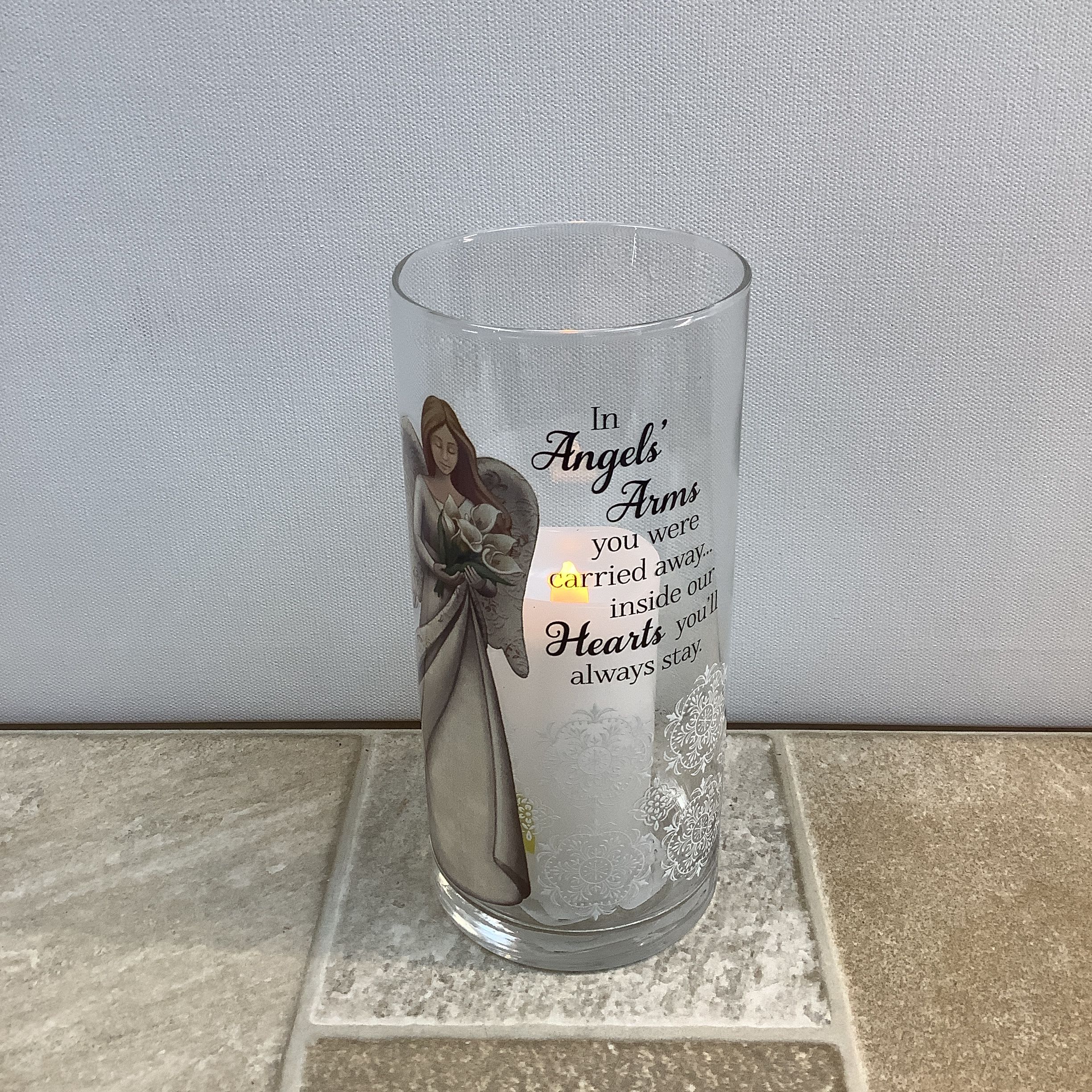 Clear glass memorial candle holder with angel artwork and text