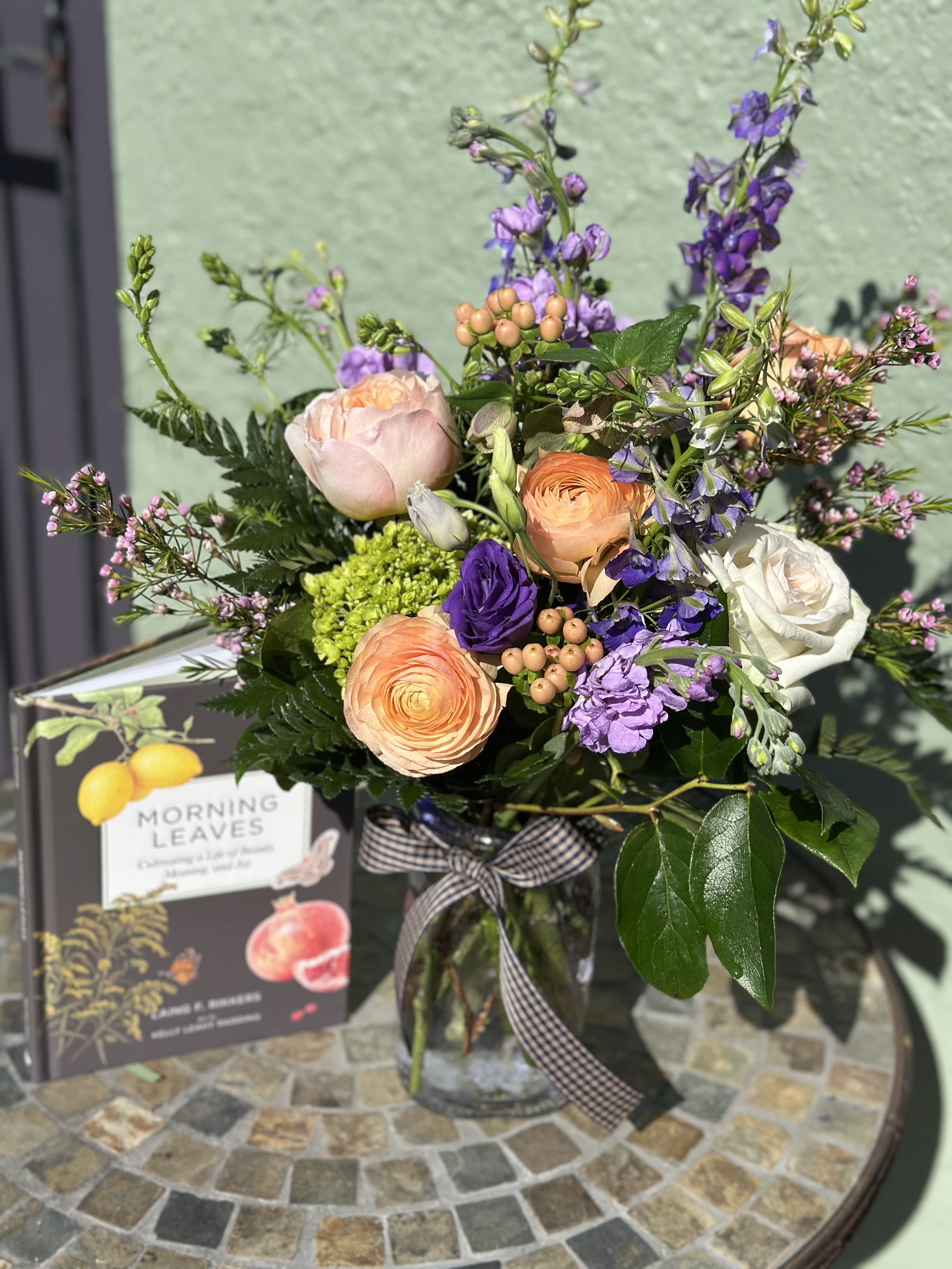 Morning Leaves Book &amp; Flowers - Introducing "Morning Leaves," a special book-and-flowers gift created in collaboration with fellow Takoma Park business People’s Book. It features "Morning Leaves" by Laing F. Rikkers, with artwork by Kelly Leahy Radding, paired with a custom-designed spring floral arrangement in seasonal peach, purple, and white blooms. Thoughtfully curated, it’s a beautiful way to celebrate the season through both story and flowers. 