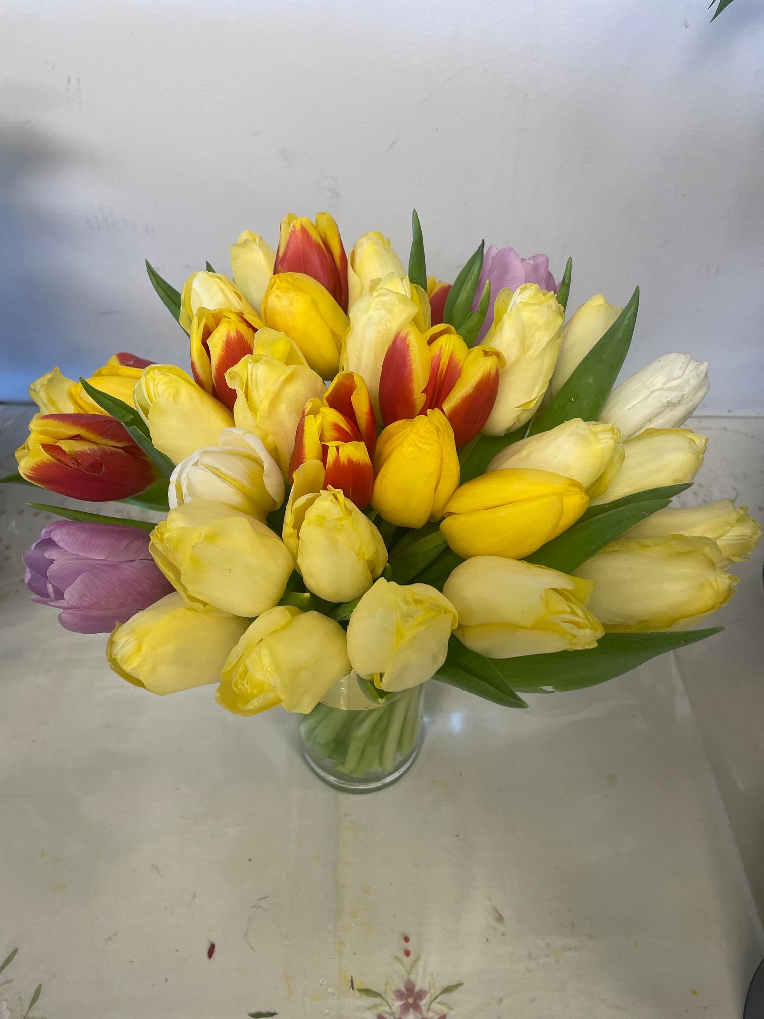 Spring is here - A bunch of bright color tulips in a clear glass vase will bring a spring atmosphere into your house someone else dear to you.