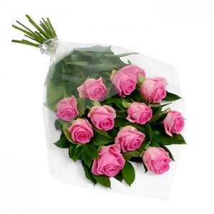 Wrapped bouquet of pink roses with visible stems in a clear plastic sleeve
