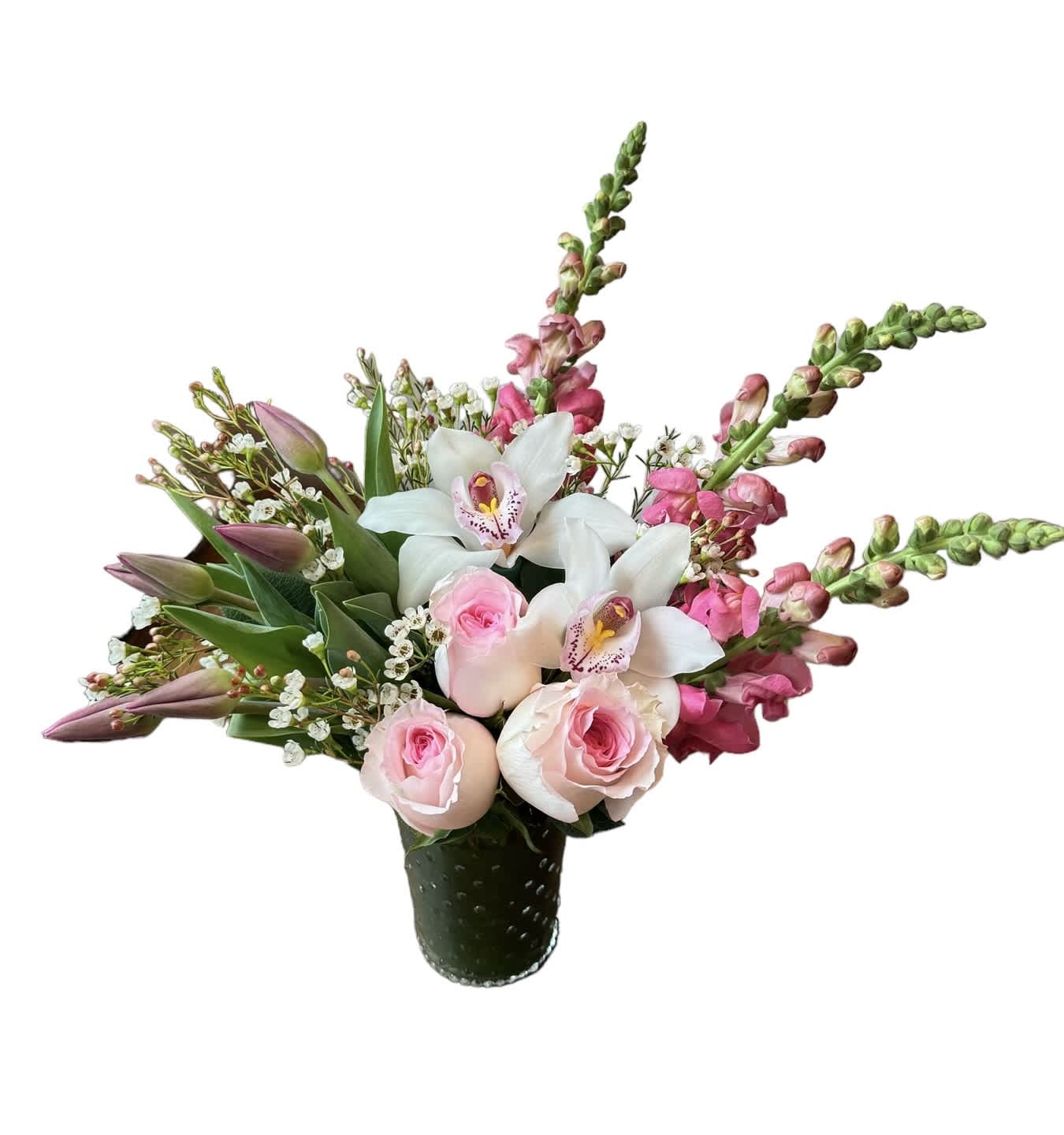 Pink roses, white orchids, and pink snapdragons arranged in a green textured glass vase