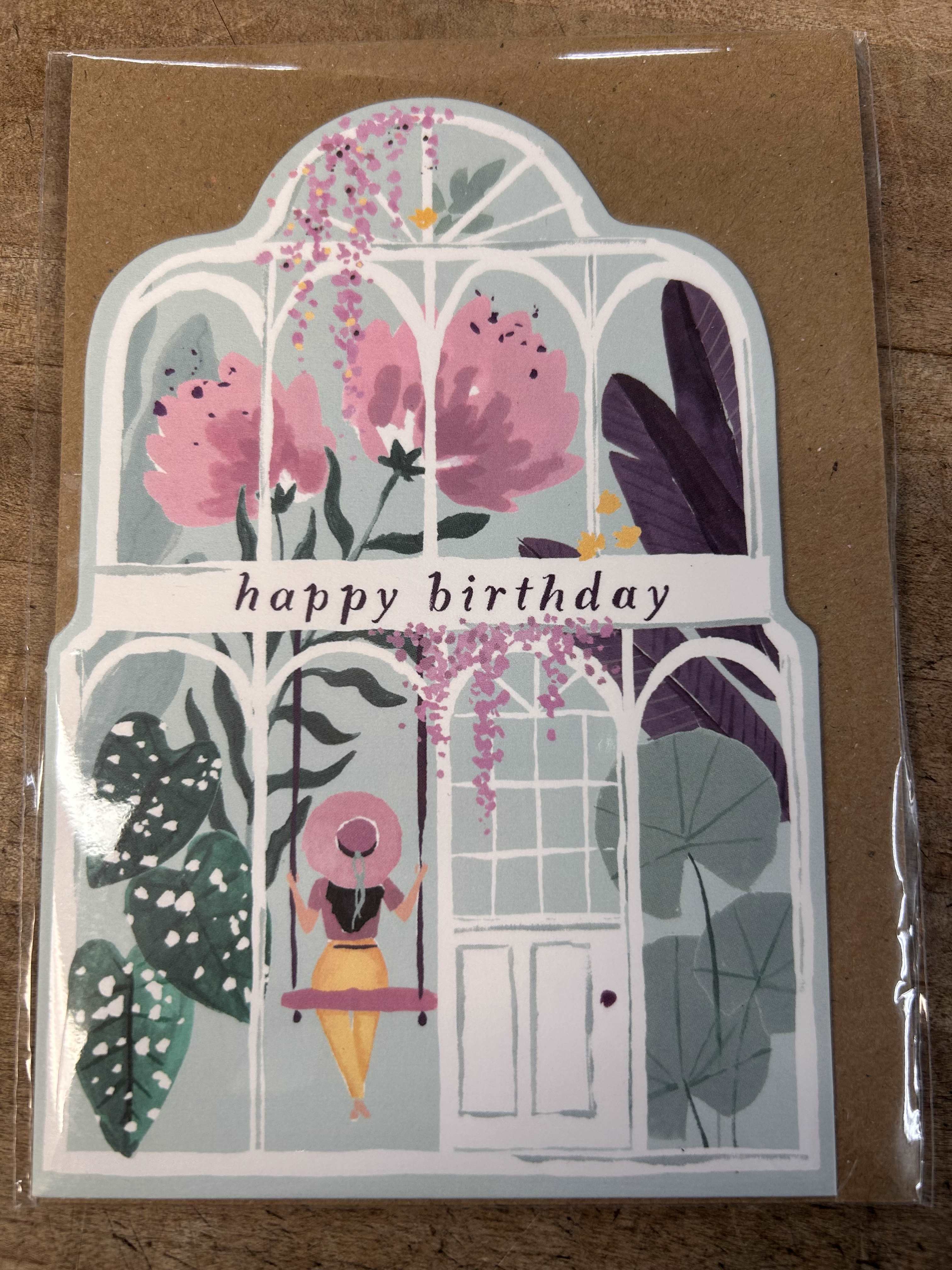 Happy birthday greeting card with greenhouse and woman on a swing illustration