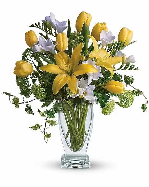 Spring Rhapsody - A rhapsody in yellow. Say "get well soon" or "have a happy day" with this sunny assorted bouquet. Everyone's favorite spring flowers are here; yellow lilies, yellow tulips, with accents of deliciously fragrant freesia flowers. Vase subject to availability and will be replaced with similar if unavailable.  