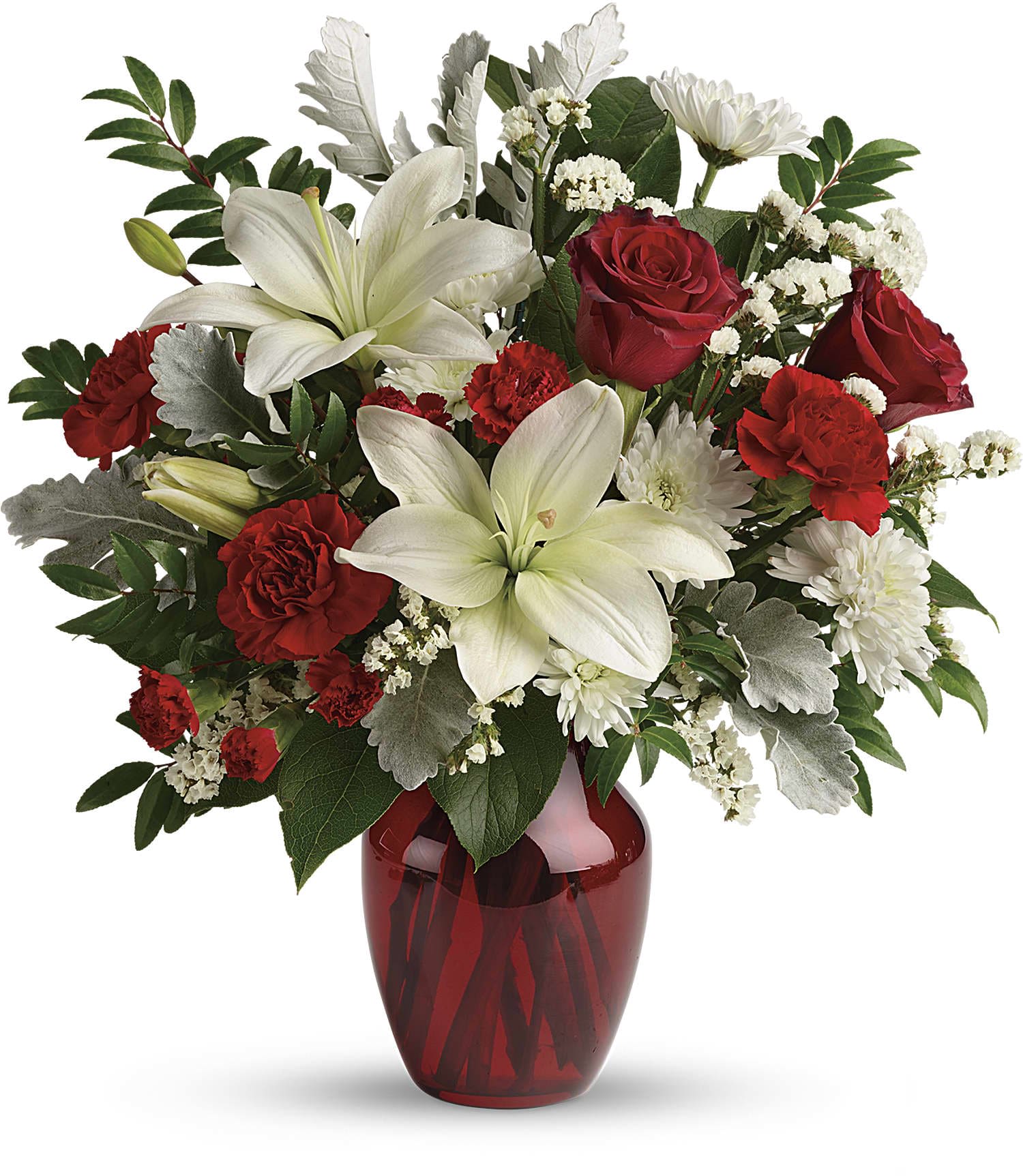 Red and white arrangement with lilies, roses, and carnations in a red glass vase