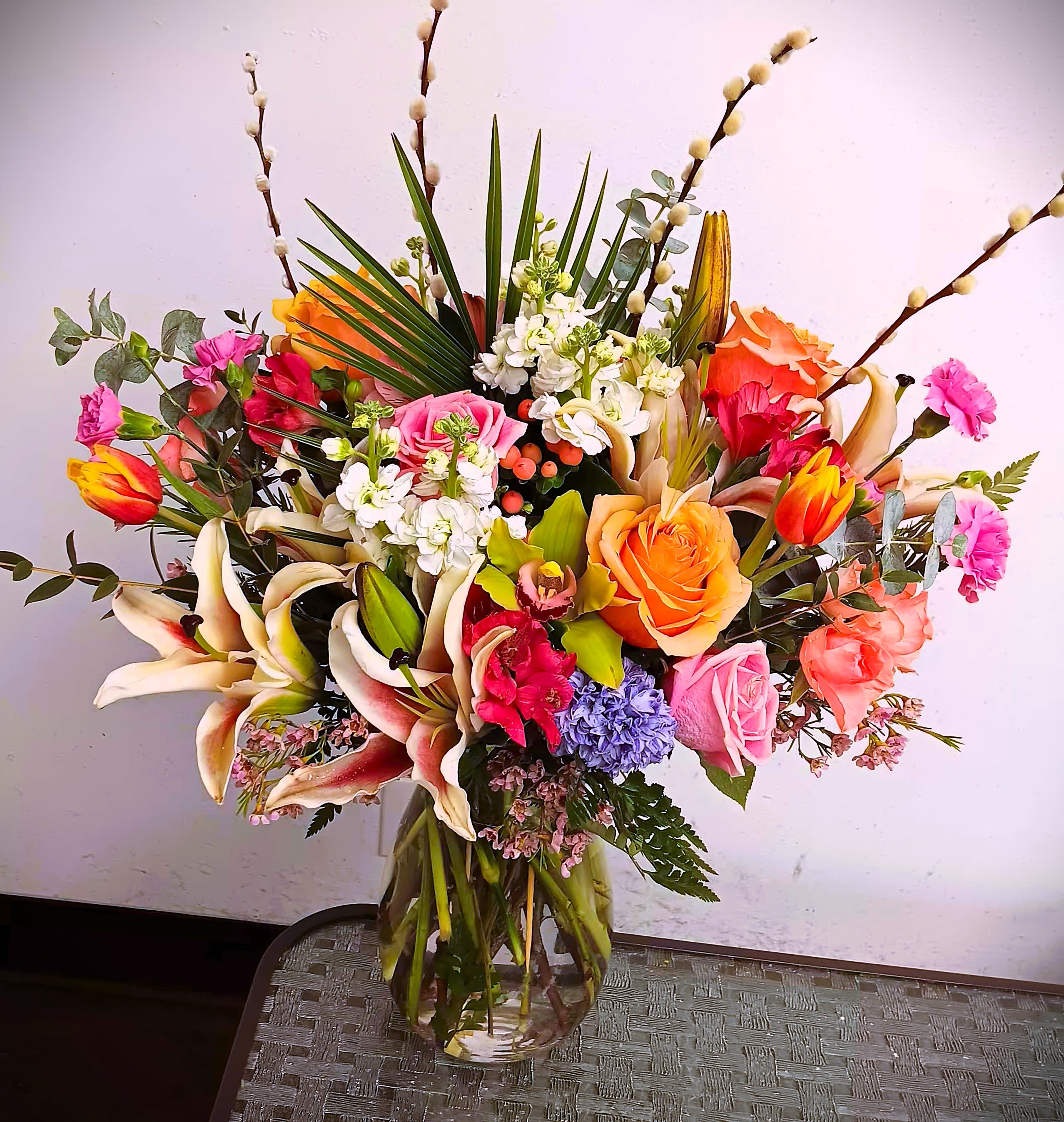 Spring in Dallas - Order this beautiful spring arrangement with roses, tulips, orchids, stock, lilies, and many other spring flowers. It comes in a clear glass vase, and is great for any occasion. We deliver!