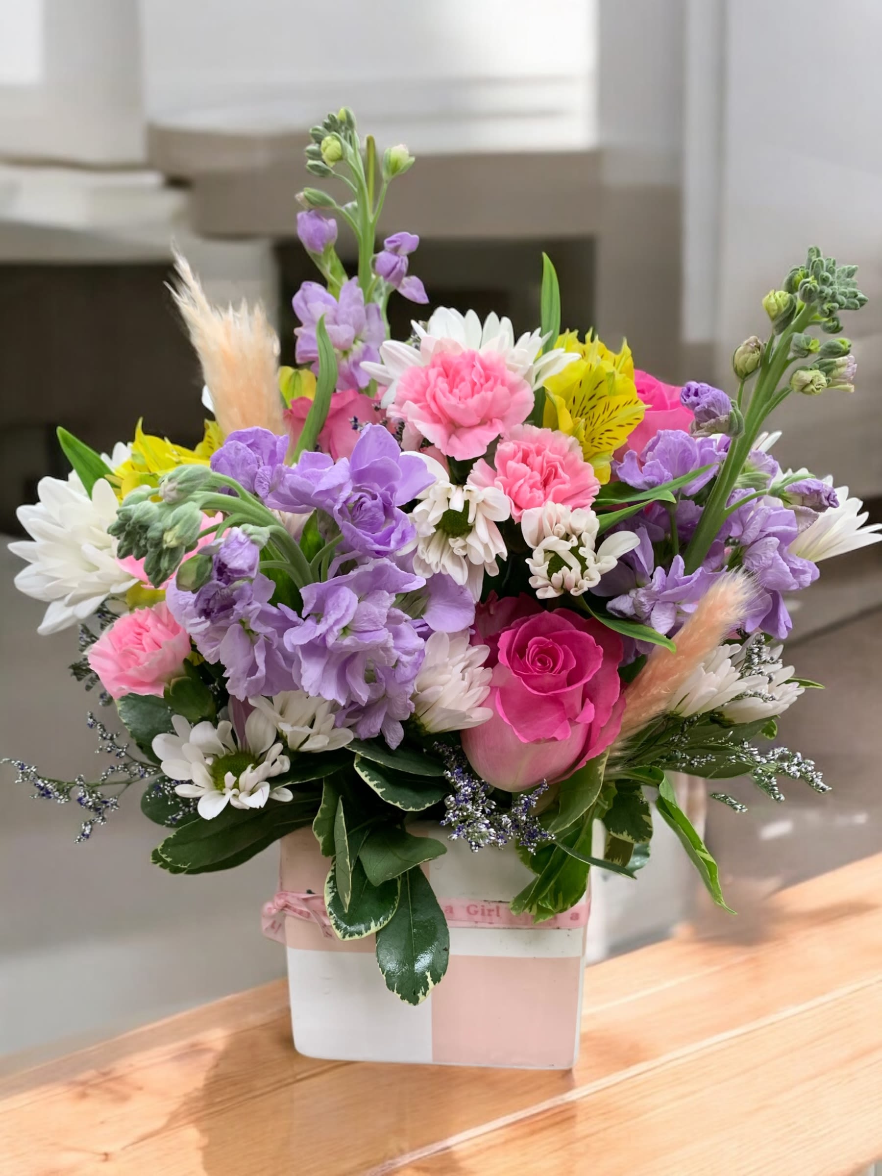 Isn’t she lovely - Soft, feminine and cheerful. This lovely combination of stock, roses and beautiful blooms bring life to a lovely ceramic container that will be reused for years to come.