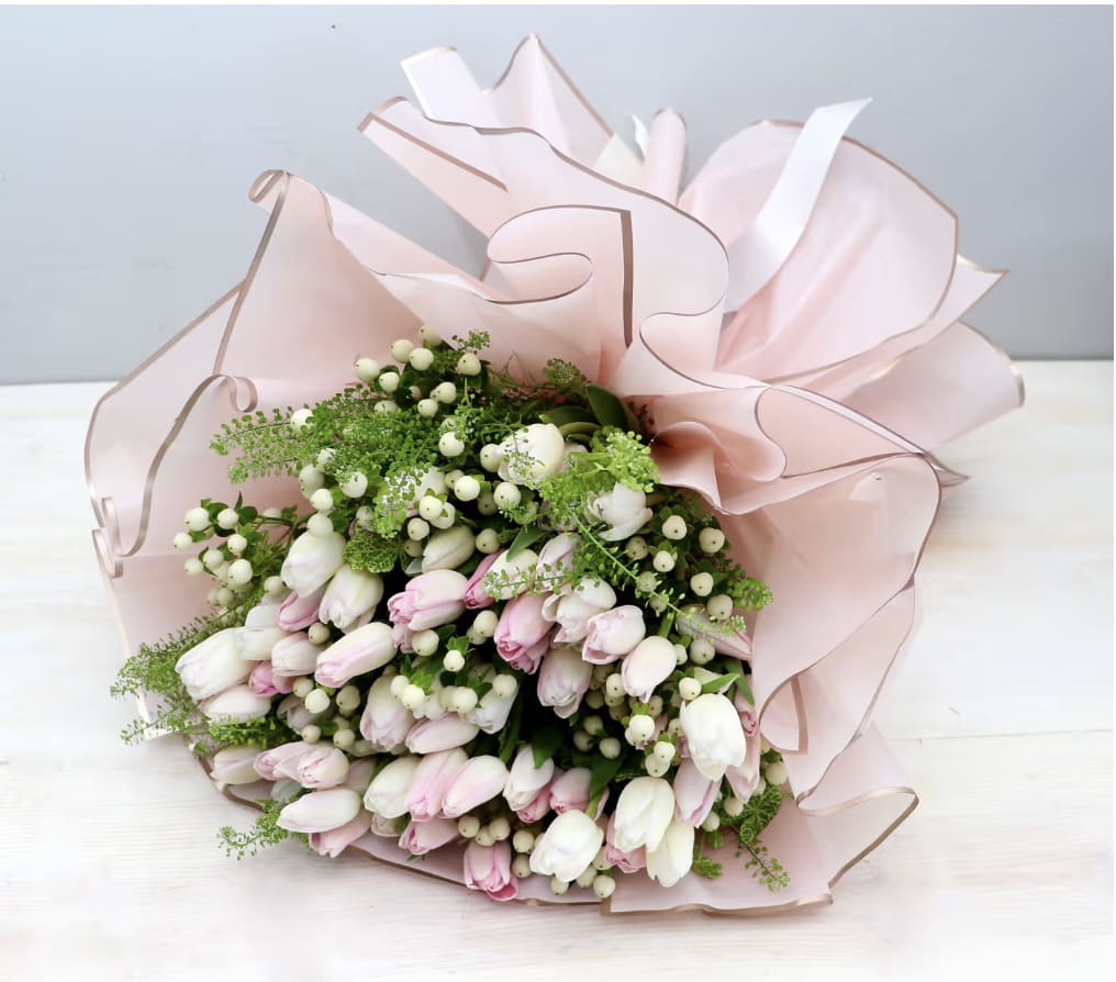 Tulip Bouquet - WeHo  - The bouquet shown is 4 bunches of tulips paired with seasonal greenery. Tulip color varies, you can specify what colors you'd like in the special instructions box.