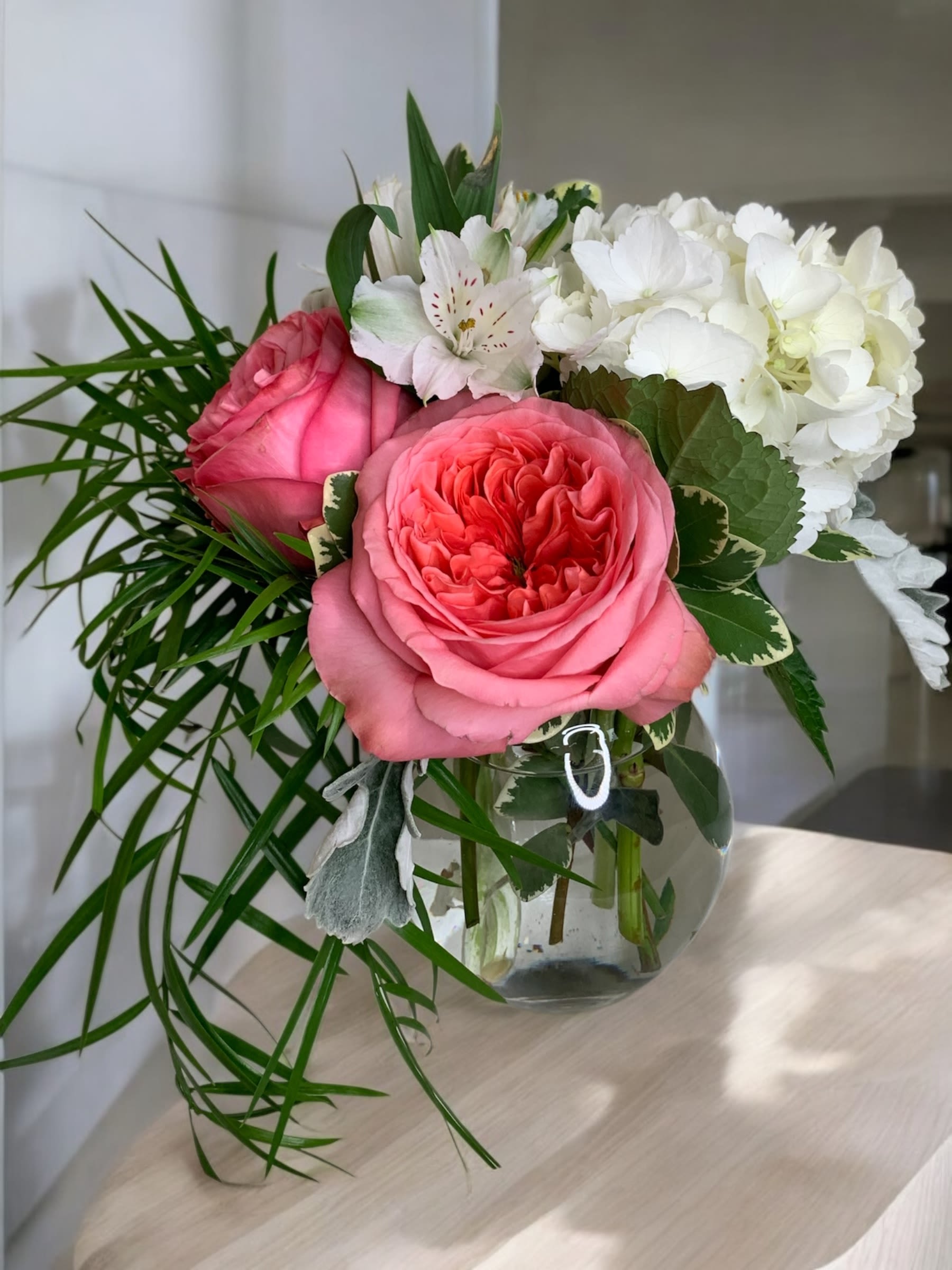 Pink roses and white hydrangeas in a glass vase