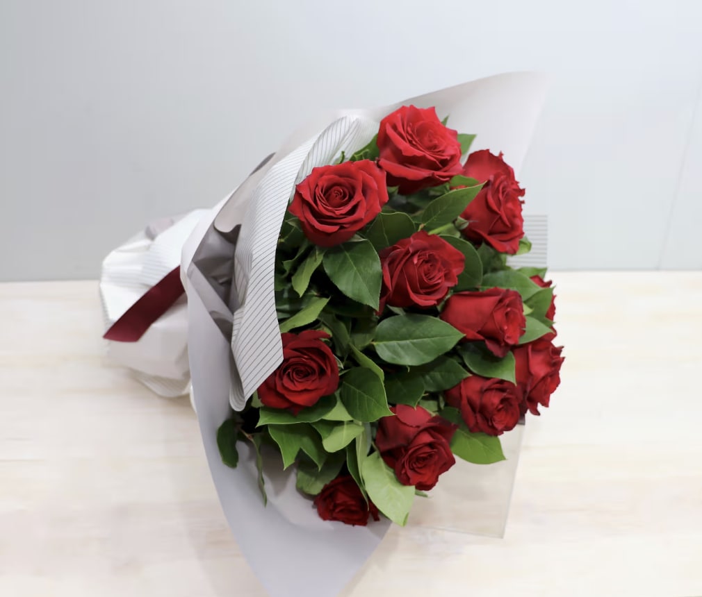 Dozen Red Rose Bouquet - WeHo  - One dozen red roses wrapped. Deluxe upgrade holds two dozen, and premium upgrade holds three dozen.
