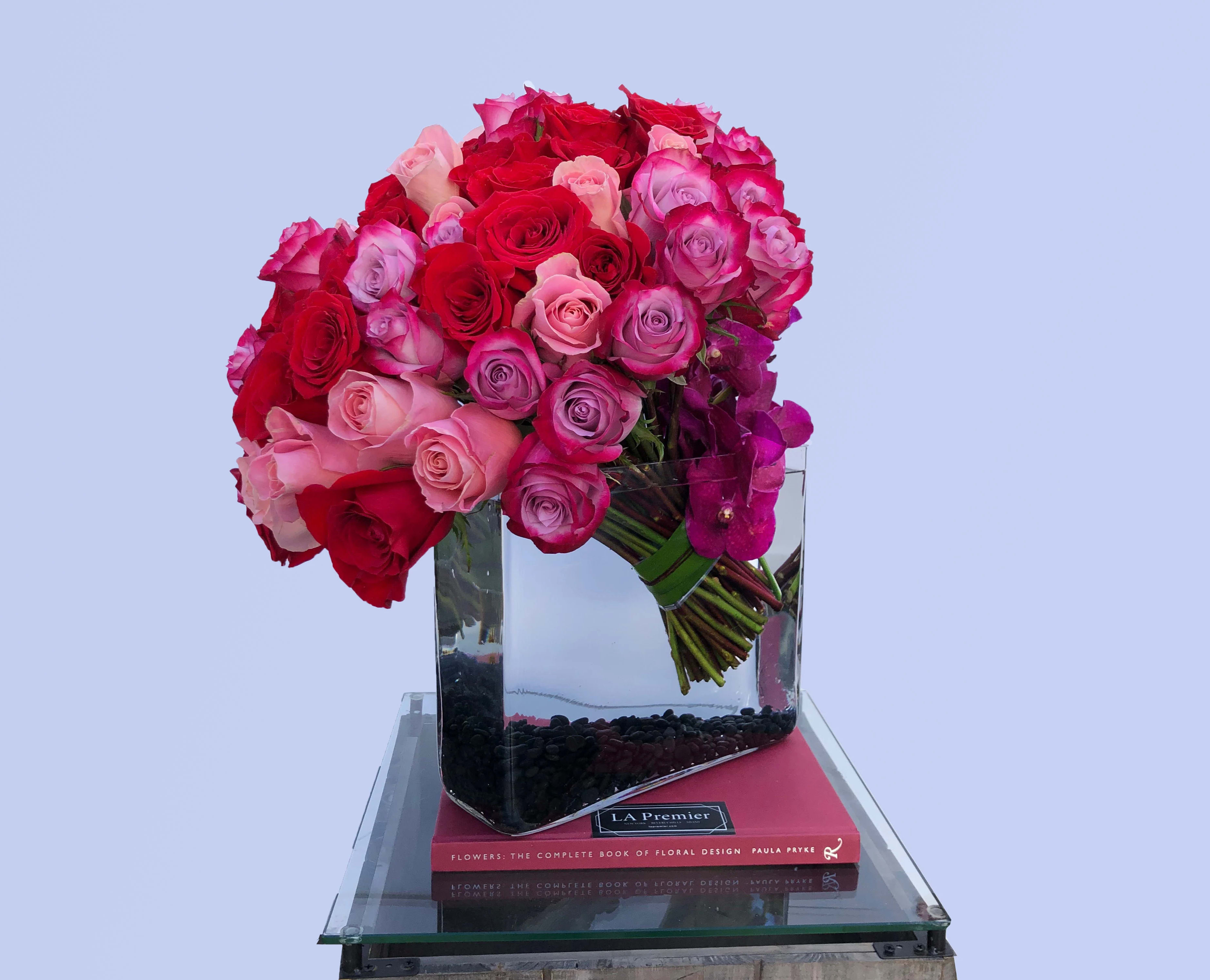 Beverly Hills Dreamer - Over two dozen Roses of varying shades of pink, purple, and red are hand-tied in a super stylish and modern arrangement... Made even more luxurious with Vanda Orchids!