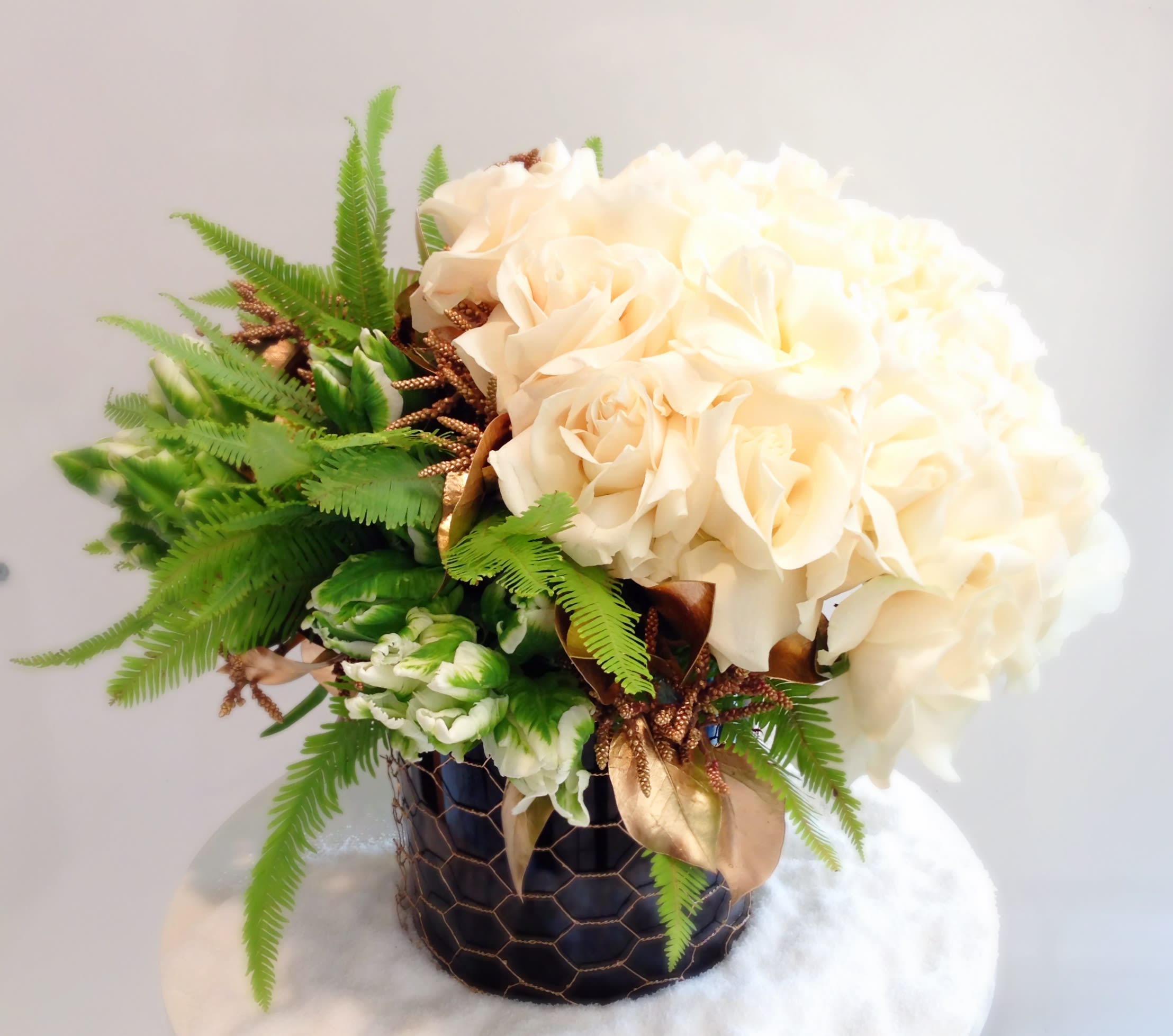 Polar Queen - Crisp white Roses and Tulips are accented with Ferns and gold foliage in this beautiful, petite vase arrangement