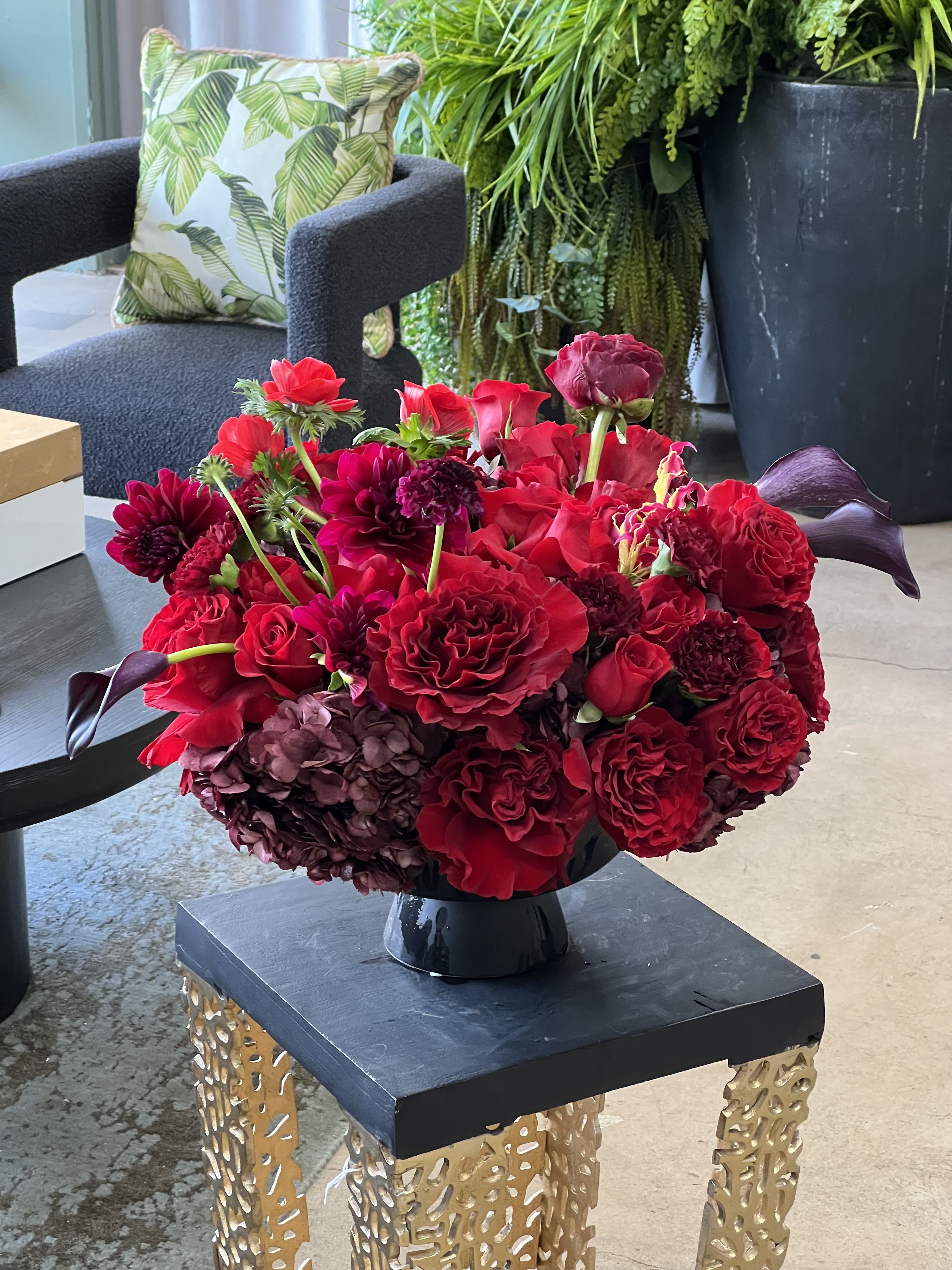 Deck of Red - A modern red and black arrangement full of bright red Roses, with an accent of mini black Calla Lilies and Umbrella Fern