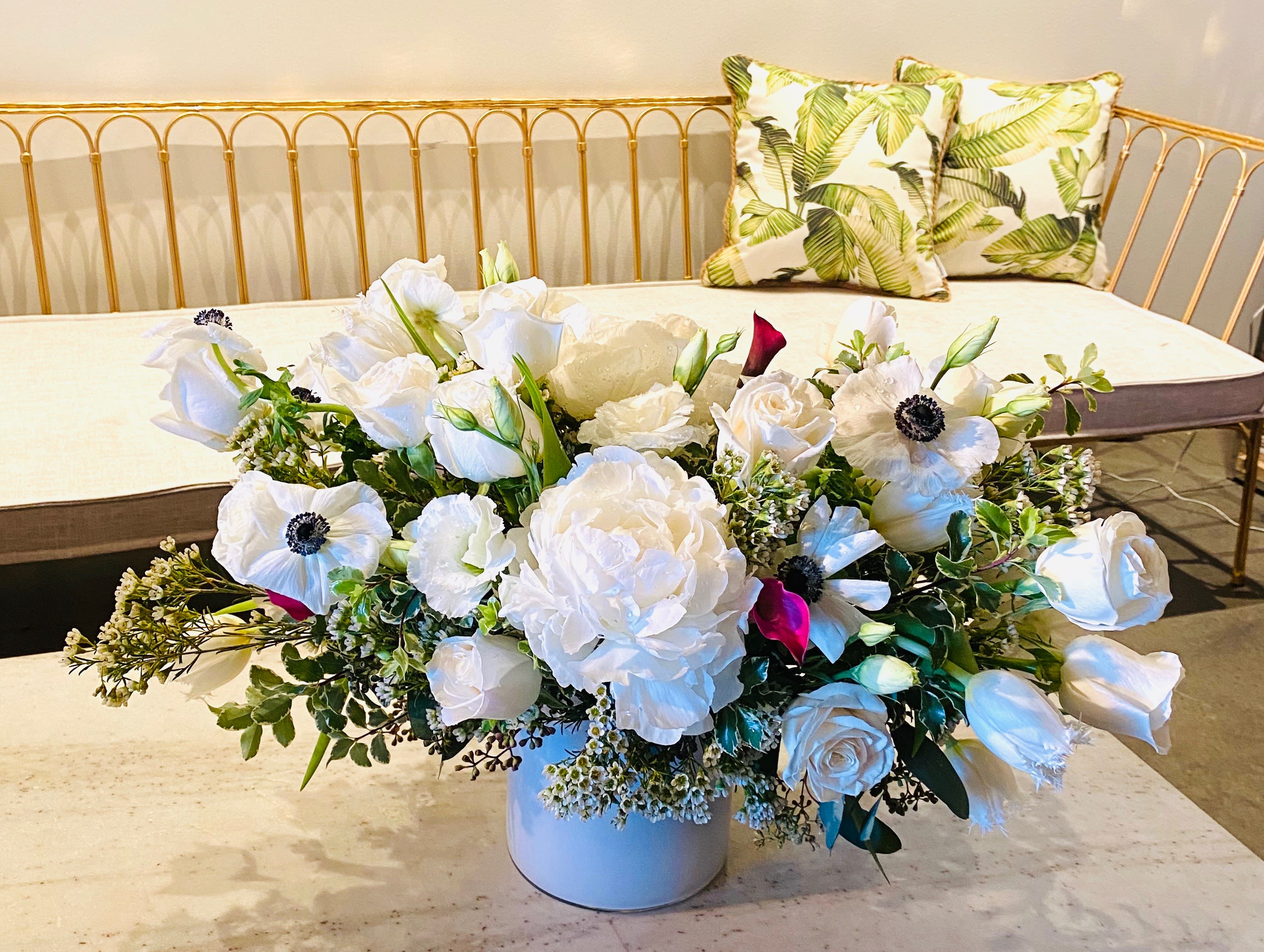 Garden White - A wonderful white vase arrangement with Roses, Peonies, Anemone, and more! With mixed greenery and Waxflower