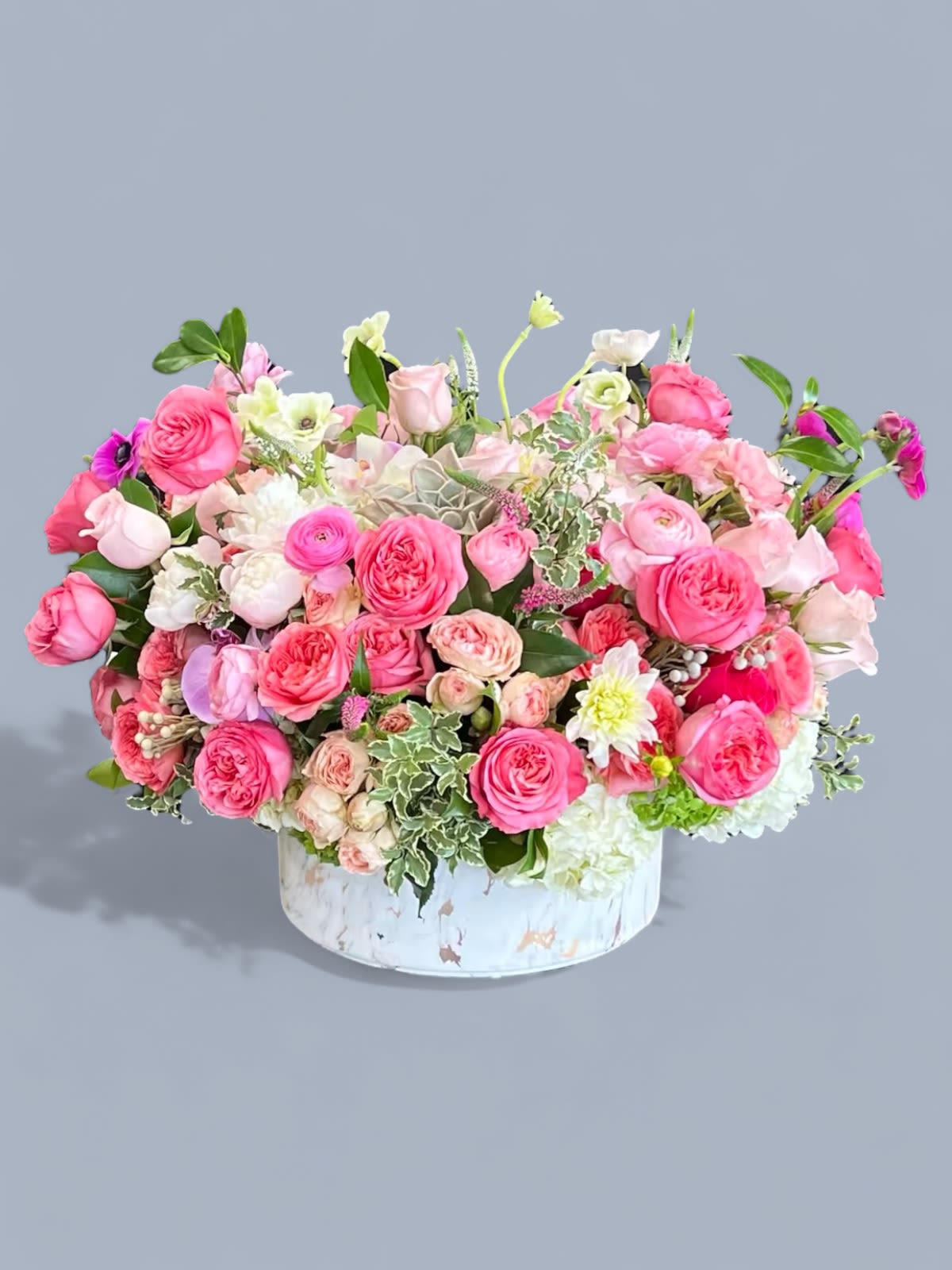 Song of Roses - This large ceramic vase arrangement is packed with deep pink Roses, Spray Roses, Ranunculus, Anemones, and assorted greenery
