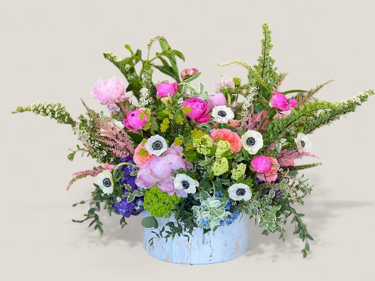 Zulema  - This large ceramic vase arrangement brings all the beauty of the garden into your home! Peonies, Anemones, Garden Roses, and Hydrangea are joined by a variety of wild seasonal flowers