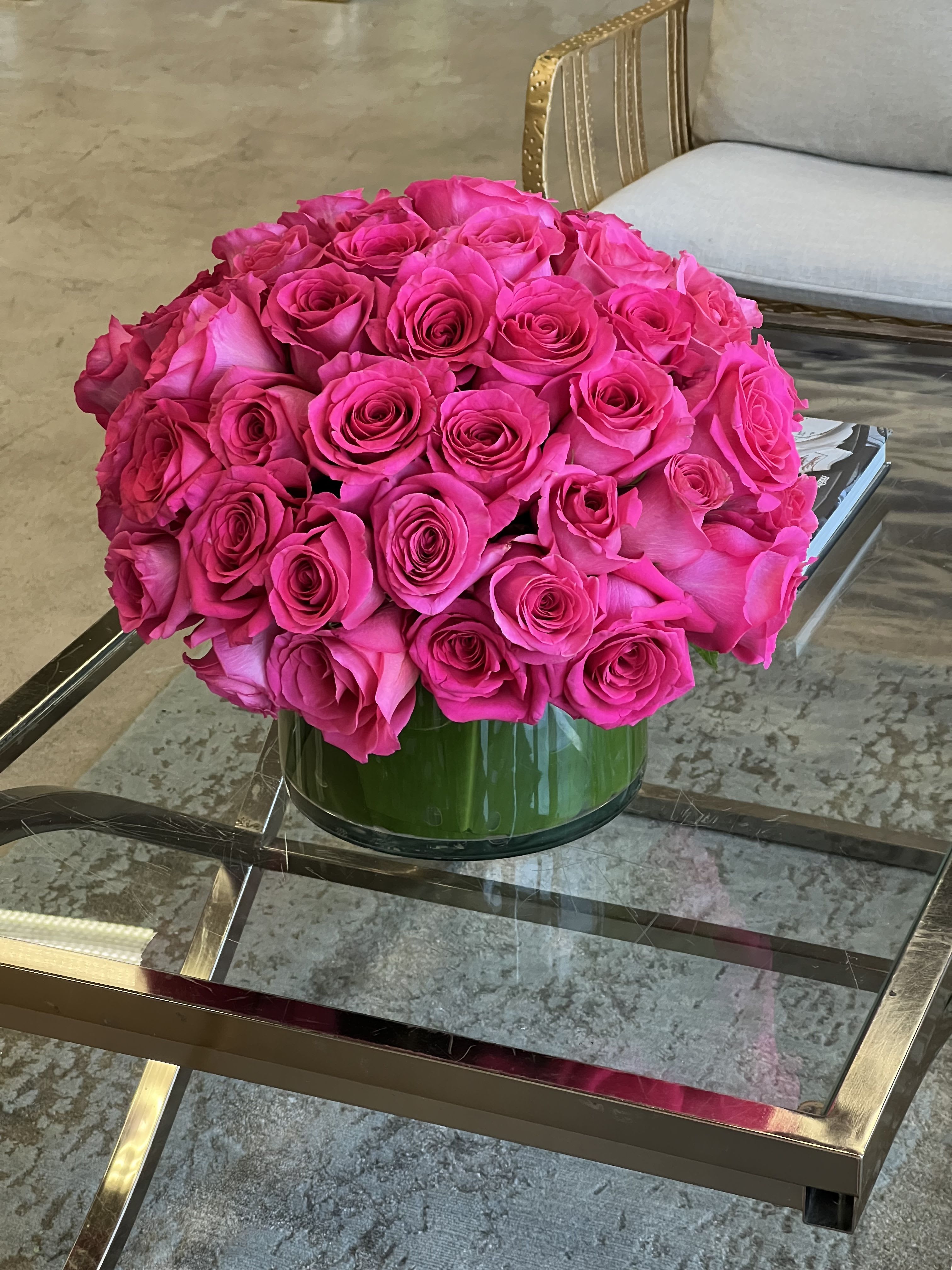 Amy - Beautiful hot pink Roses arranged in a leaf-lined glass vase