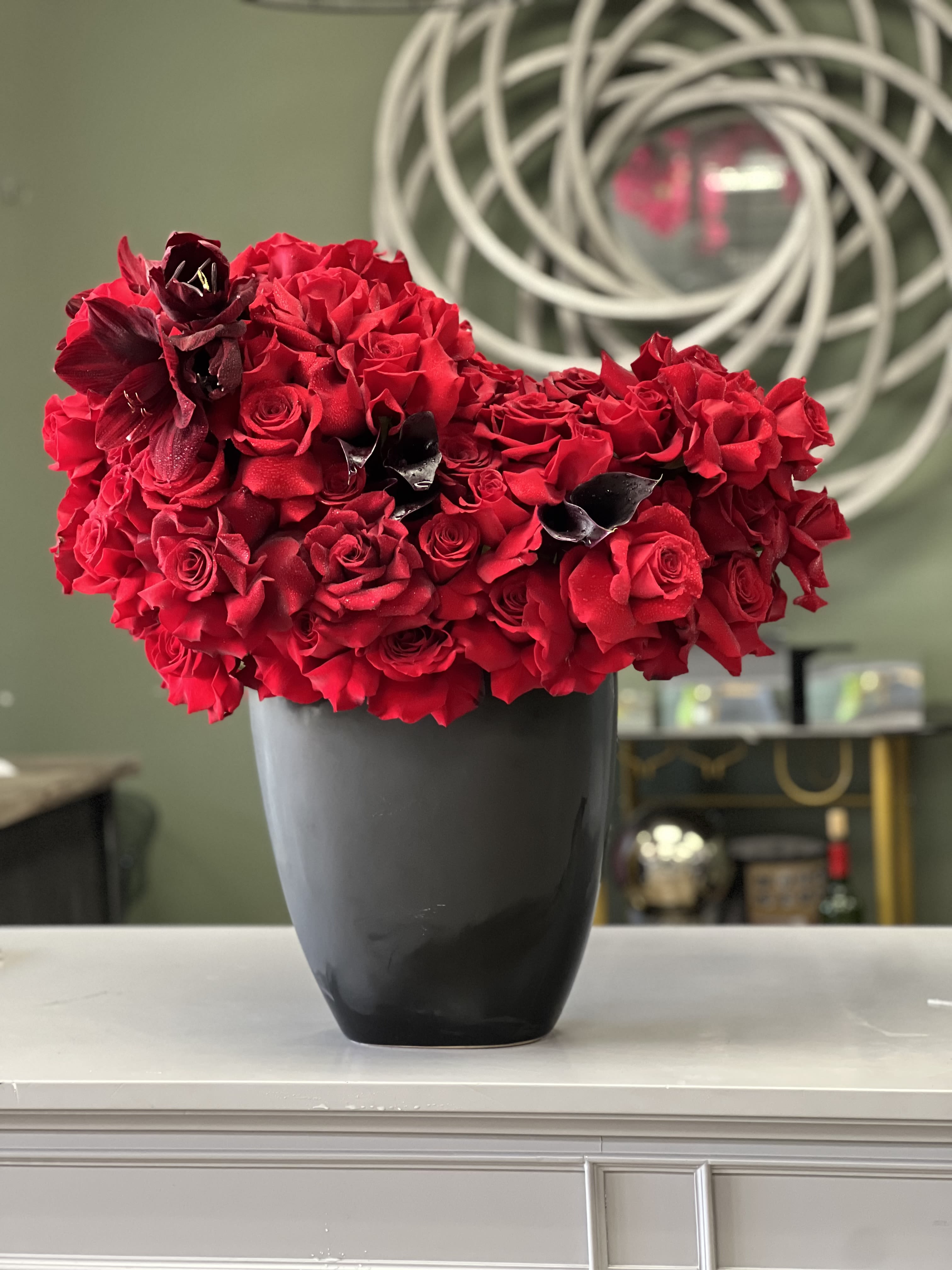 Red Hollywood  - This unique, stylish arrangement comprises reflexed red Roses and black Calla Lilies to make an unforgettable statement