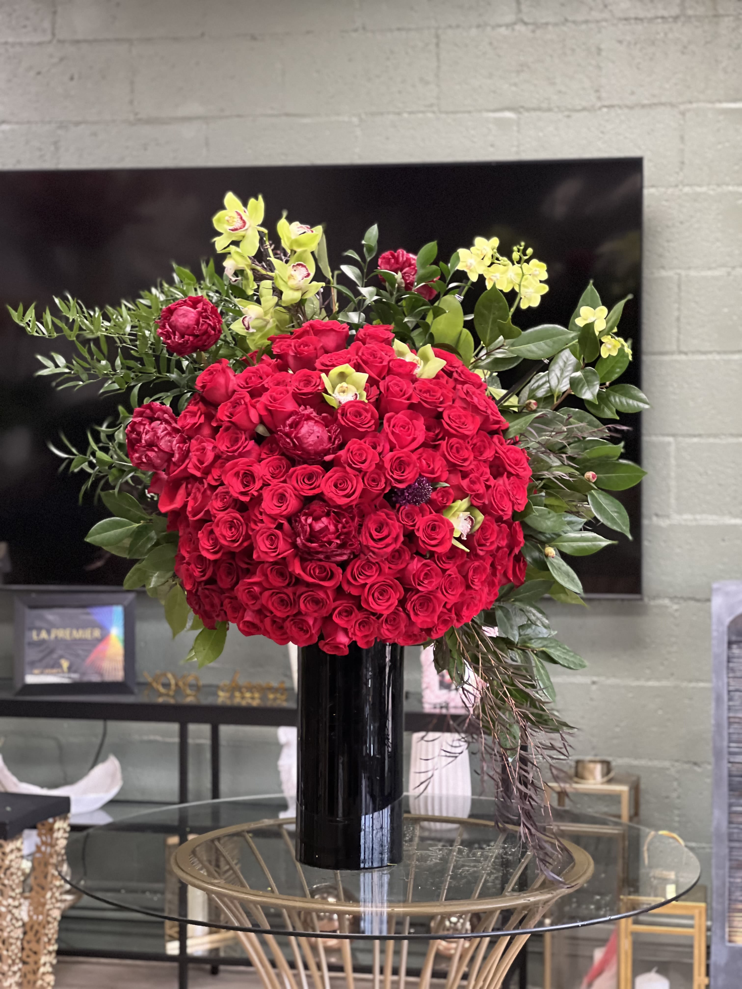 Red Freedom  - This magnificent, tall arrangement features a dazzling array of red Roses, finished with burgundy Peonies and green Cymbidium Orchids