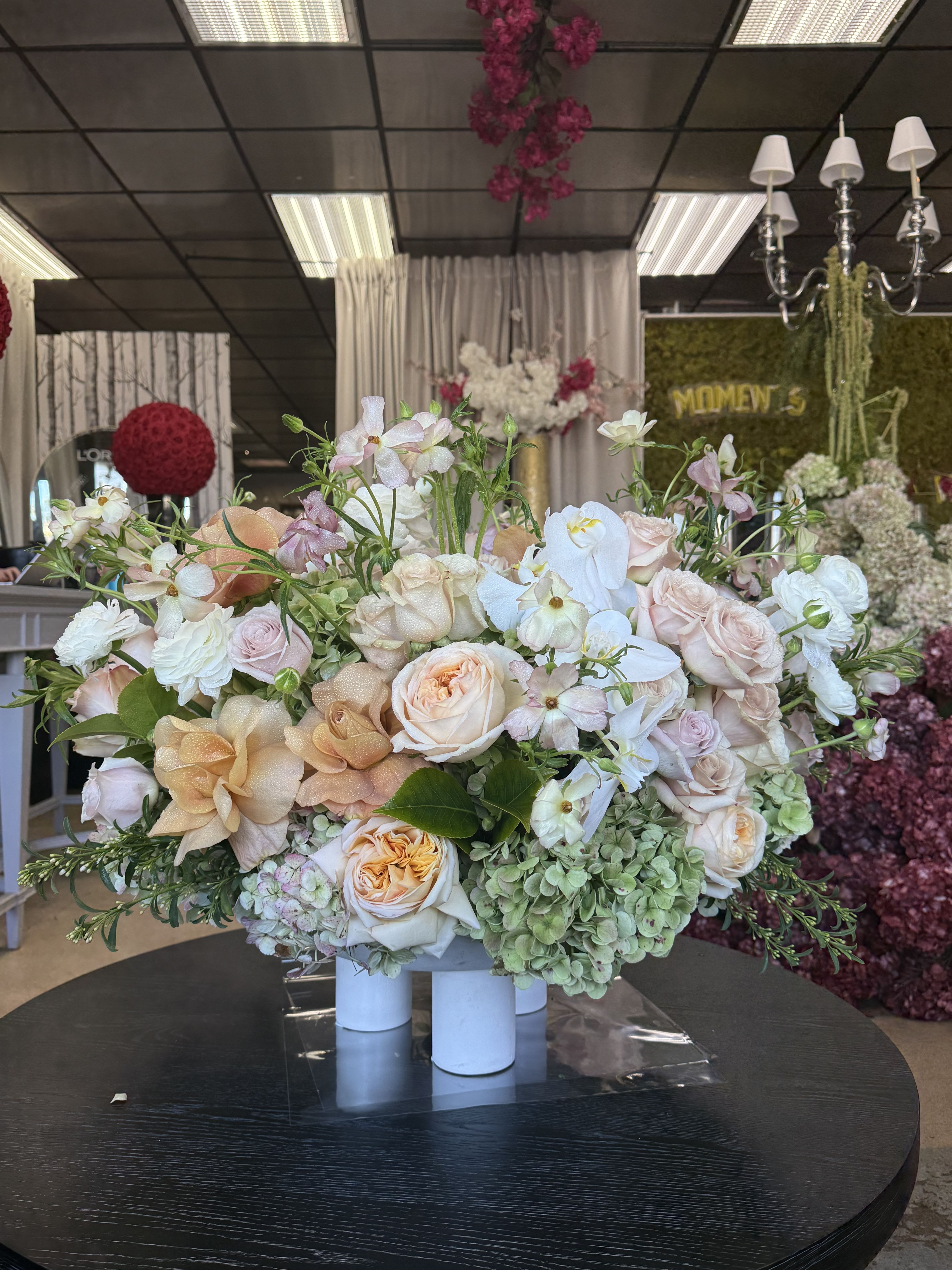 Love Me Lightly - Soft colors arranged in a low, easy-to-place arrangement. Enjoy as a gift, in your home, or as a dinner centerpiece. Featuring Roses, Garden Roses, Hydrangea, and Ranunculus