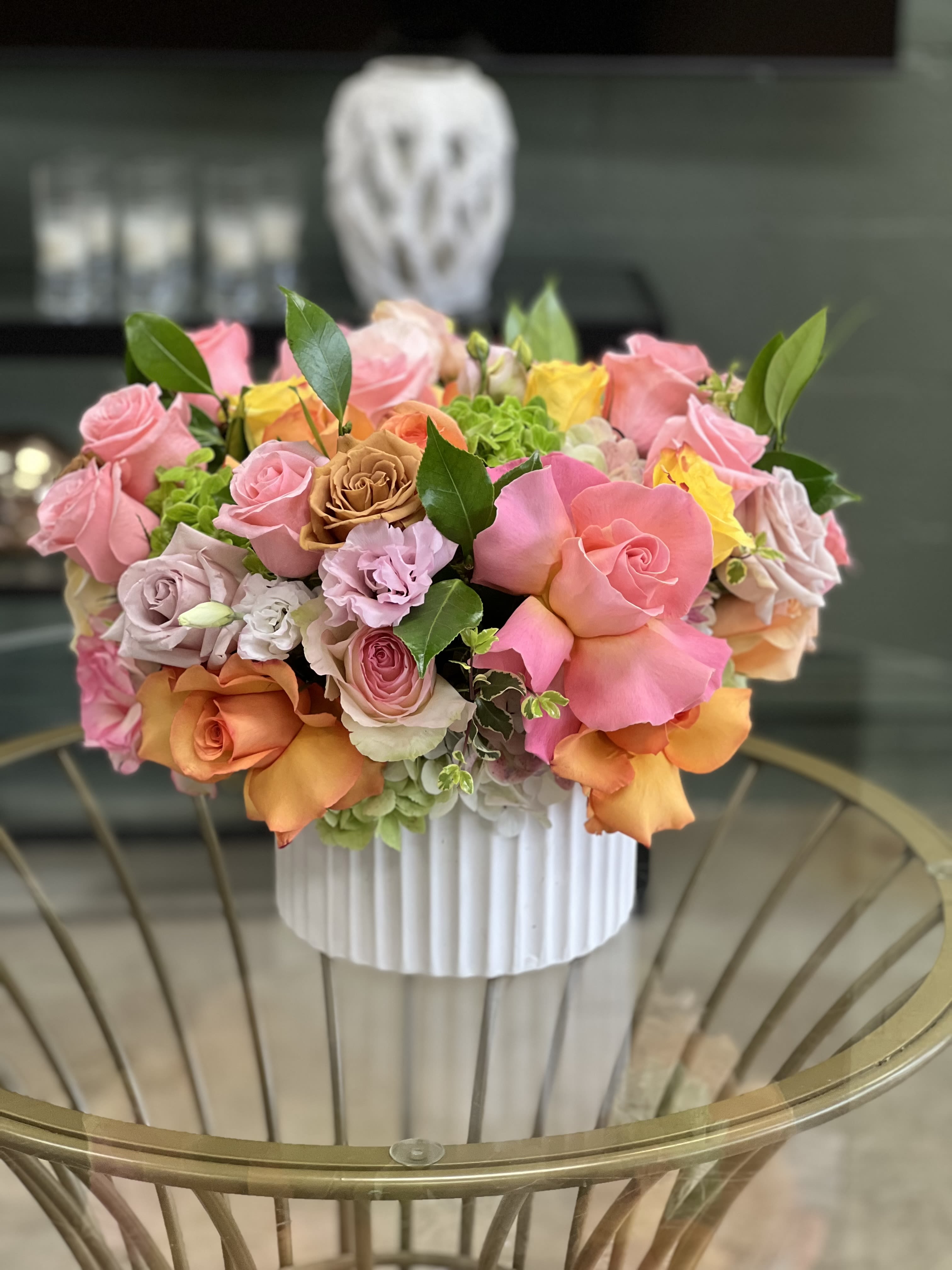 Grace - This arrangement is a colorful blend of assorted Roses with Hydrangea and greenery