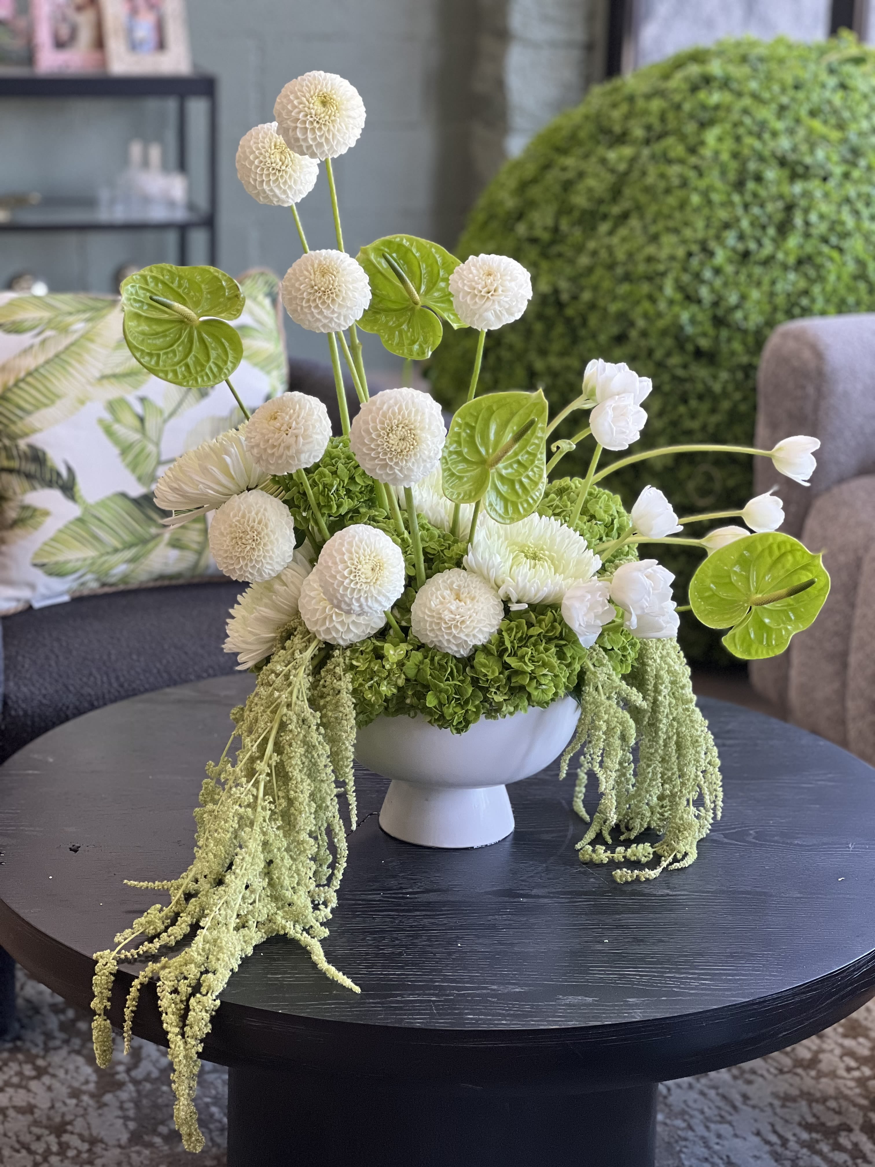 Yoga  - This fabulous, artistic floral arrangement comes in a ceramic bowl, bursting with lush green Hydrangea, striking white Dahlias, Tulips, and Chrysanthemums, finished with green Anthurium and hanging Amaranthus