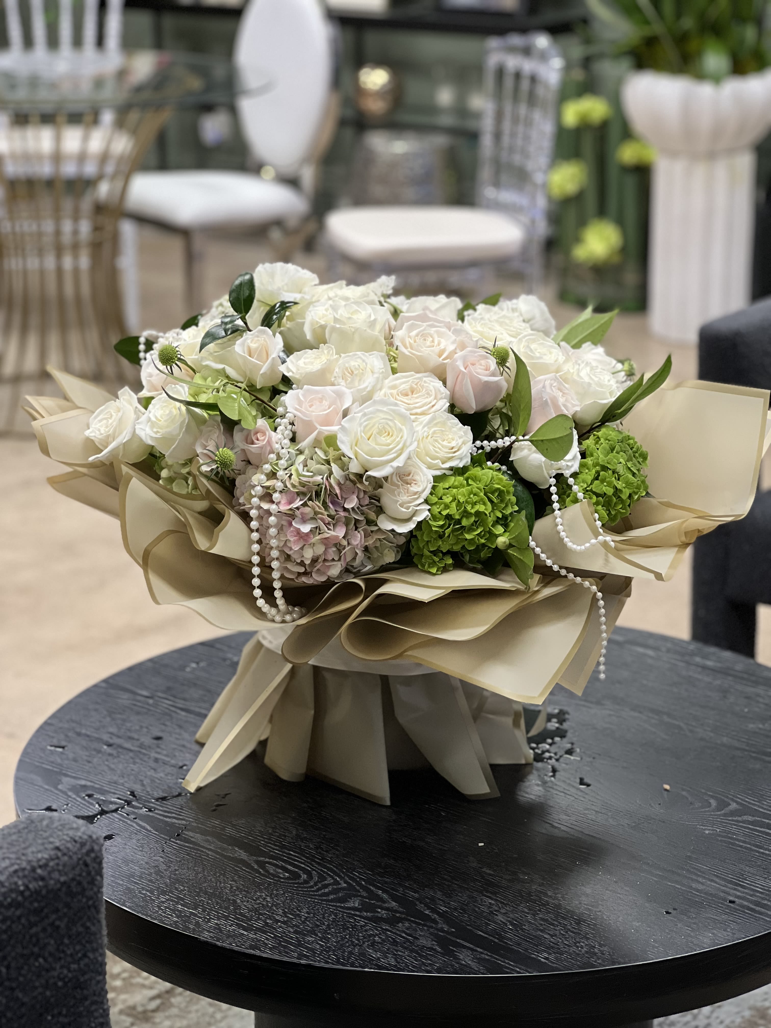 Antique Garden - This elegant, luxurious floral arrangement features white and blush Roses with antique Hydrangea, in a stylishly wrapped glass vase, and embellished with strings of pearls for a timeless touch