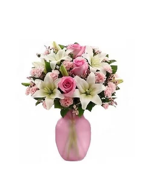 Pink roses and white lilies arranged in a pink vase