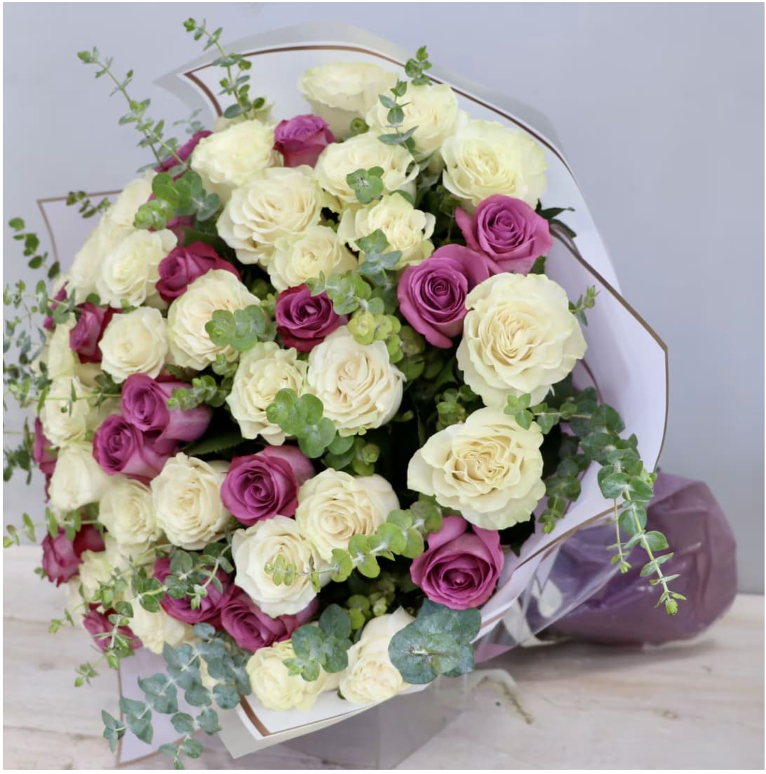 White and Purple Rose Bouquet - WeHo  - This large bouquet is made with beautiful white and purple roses and eucalyptus accents.
