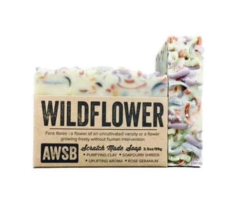 Rustic bar of wildflower-scented soap with colorful shreds and kraft paper label