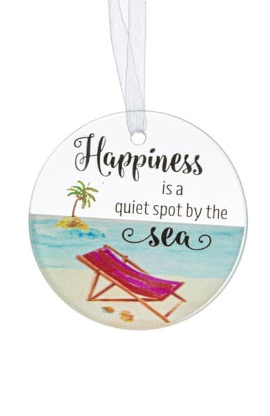 Round hanging ornament with beach chair art and the words 'Happiness is a quiet spot by the sea'.