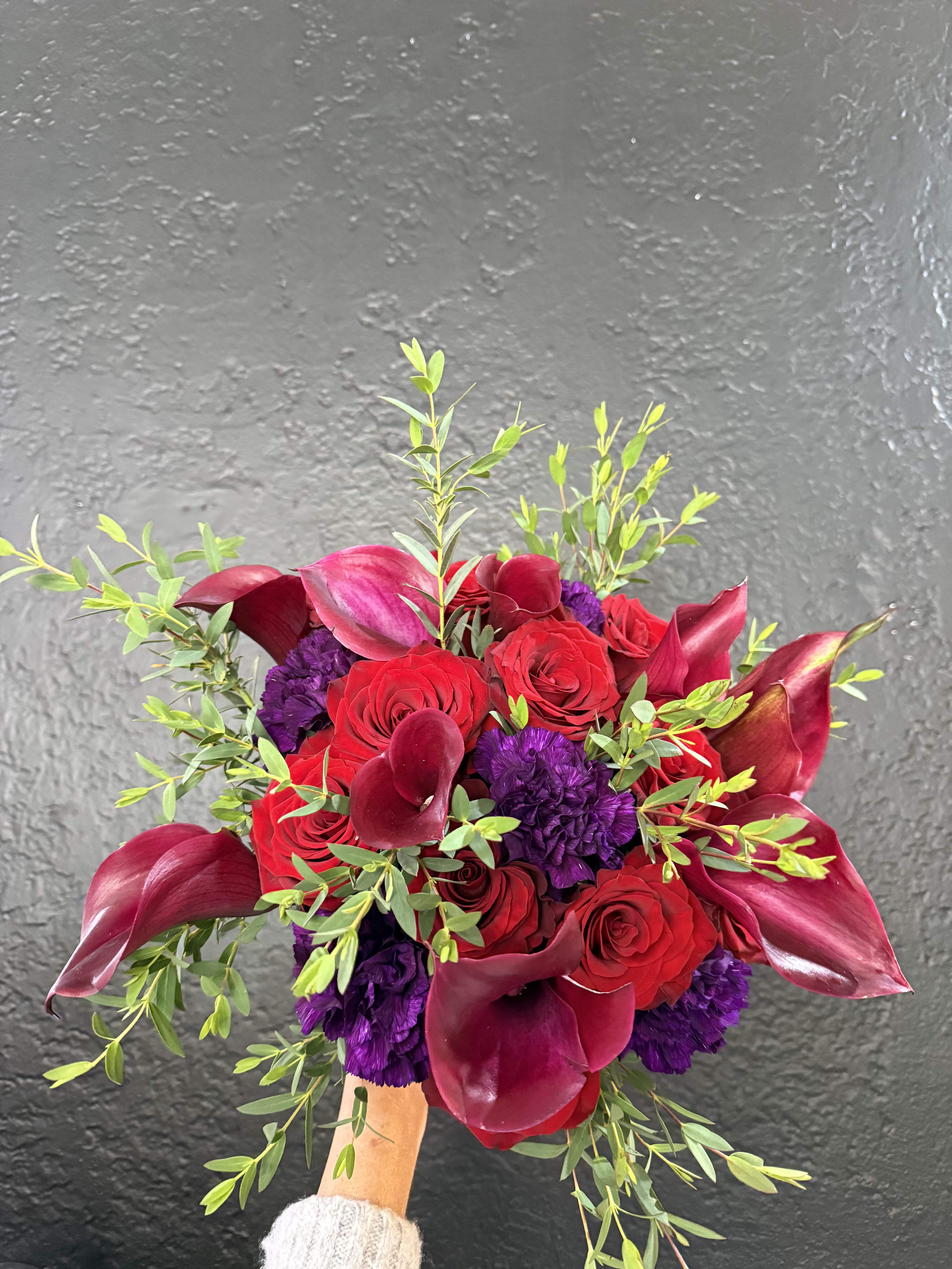 Deep Color Bridal Bouquet - A striking mix of deep purple and red blooms like calla lilies and roses. Dramatic, luxurious, and eye-catching.