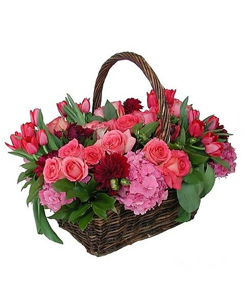 A Floral Picnic - Roses, Tulips and Hydrangea in a wicker picnic basket. 
