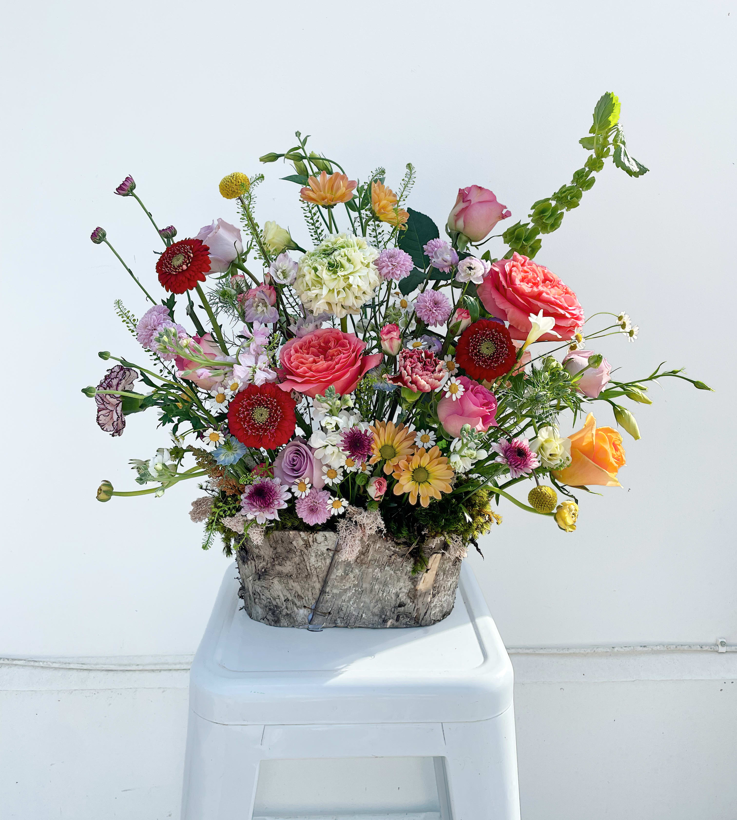 Garden in Bloom (Designer's Choice) - A vibrant, garden-inspired mix of seasonal blooms, Easter Morning Glow is a custom, one-of-a-kind arrangement designed to capture the joy and color of spring. Overflowing with texture and movement, each piece is uniquely crafted to evoke fresh, effortless beauty.  For an extra festive touch, it’s also available in an Easter basket upon request.