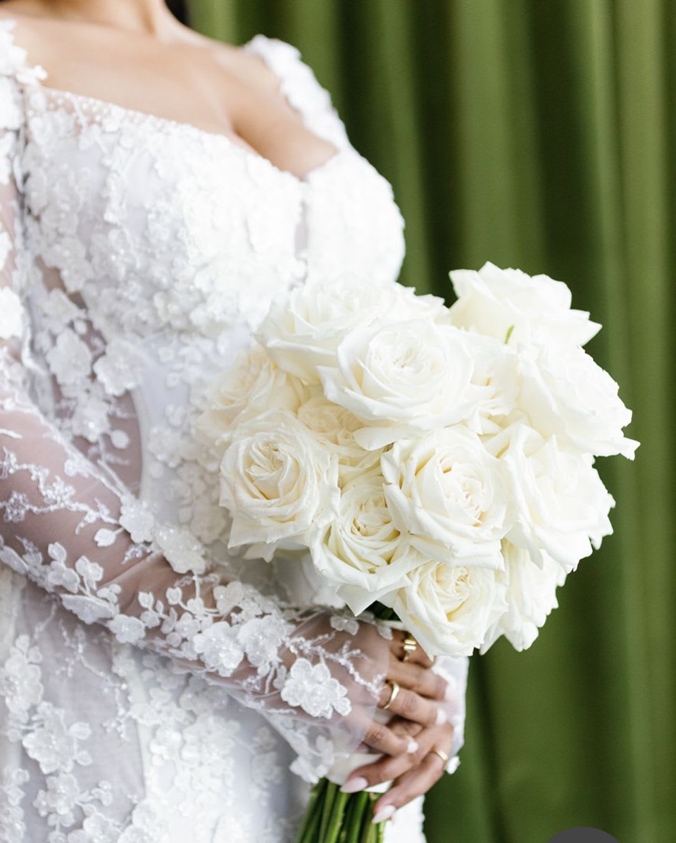 Bride holding a bouquet of white roses