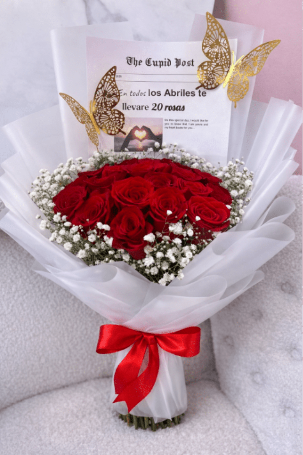 Forever 20 Roses -   A delicate and elegant bouquet featuring 20 premium red roses, the perfect symbol of love and passion. Wrapped in fine white Korean paper that enhances the richness of each bloom, this arrangement is complemented by subtle details that add a modern and sophisticated touch. Ideal for surprising someone special and expressing deep emotions on any occasion. 