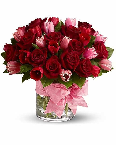 P.S. I Love You - Tell someone I love you! with two of nature's most beautiful blooms &amp; fragrant crimson roses for romance, and delicate pink tulips to signify friendship and devotion. Accented with a big, bold pink bow, this magnificent floral gift will create a sensation.