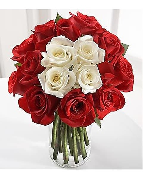 Vision - A vision of blossoming beauty that takes your breath away. A cluster of white roses is encircled by red stems to create a symbol of love's intentions.