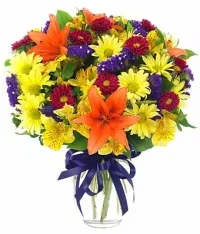 Sunny Celebration Bouquet - A bright and cheerful celebration bouquet bursting with color and joy. This vibrant arrangement features yellow daisies, orange lilies, yellow alstroemeria, and red carnations or Matsumoto roses (depending on availability), accented with purple statice for a lively contrast.  Perfect for birthdays, congratulations, or any festive occasion, this bouquet is designed to bring happiness, warmth, and vibrant energy to anyone’s day.