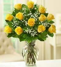 Sunny Dozen Yellow Roses - A bright and uplifting arrangement featuring one dozen vibrant yellow roses beautifully accented with delicate baby’s breath and fresh greenery, arranged in a clear glass vase. This classic design highlights the cheerful beauty of yellow roses, symbolizing friendship, joy, and warm wishes. Perfect for celebrations, thank-you gifts, or simply brightening someone’s day, this timeless bouquet brings sunshine and happiness to any setting.