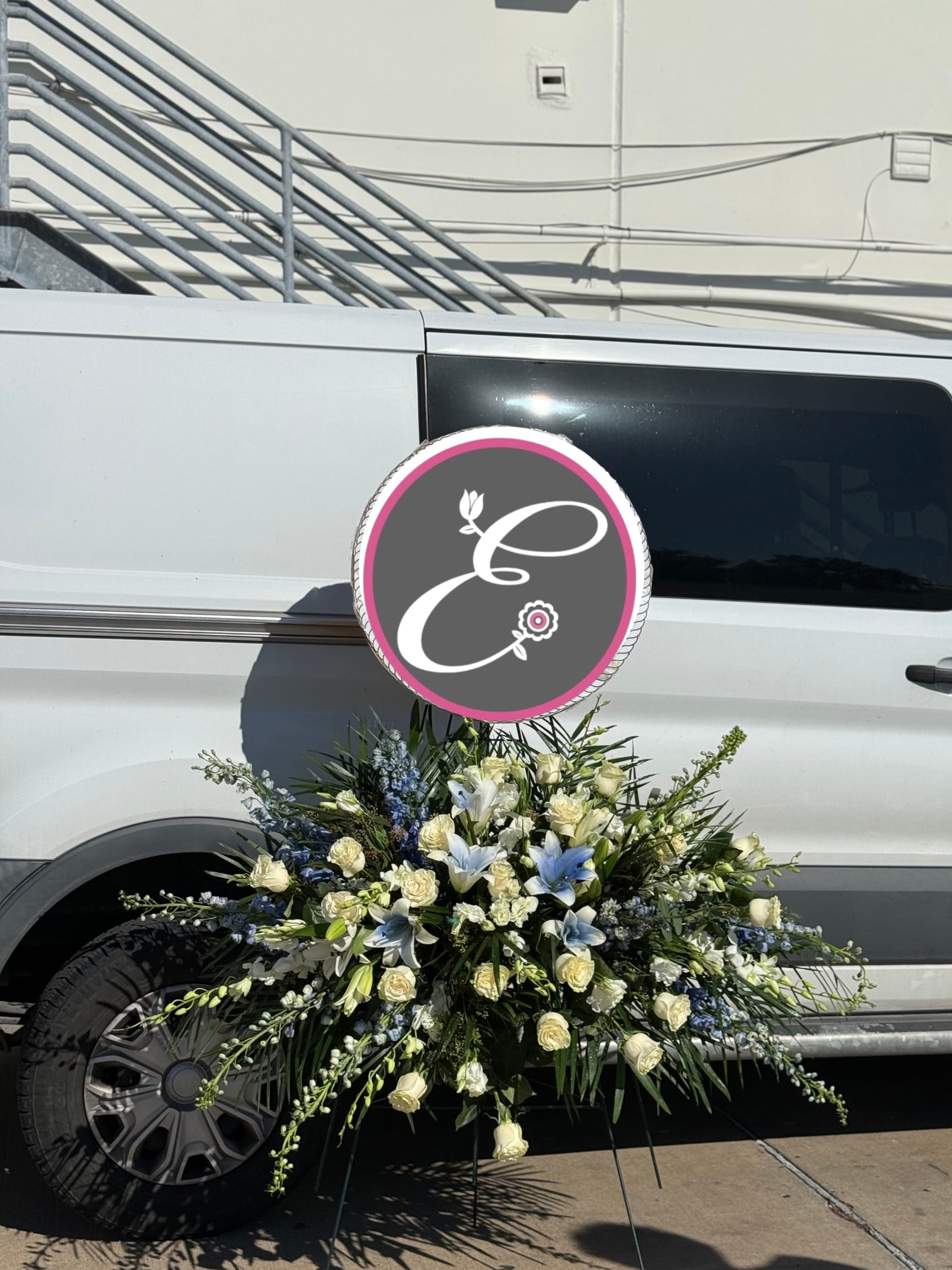 Large white and blue floral spray arranged on a vehicle