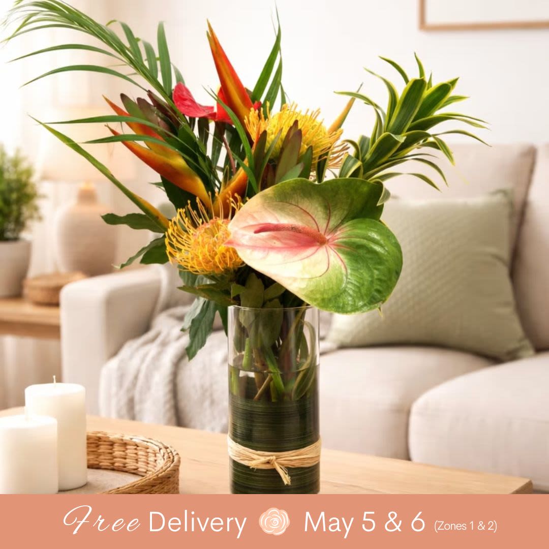 Tropical Brilliance for Mom (Featuring local Hawaiian Flowers) - This Piece is filled with colorful, local tropical flowers, creating a vibrant and cheerful display that will brighten up any home! LOVE THIS ONE for its stunning mix of exotic blooms, and trust us—it’s bigger than you think, making a bold statement in any room.  Key Features: Colorful Tropical Flowers: A vibrant mix of local tropical blooms, bringing the beauty of Hawaii into your home. Perfect for Any Room: Ideal for brightening up the living room, dining area, or even an office space. Bold and Lush: This arrangement is larger than it appears, adding a rich, full look to any space. Fresh and Exotic: Featuring flowers that capture the essence of the islands, bringing warmth and joy. A Statement Piece: With its striking colors and vibrant blooms, this arrangement is sure to be a conversation starter.