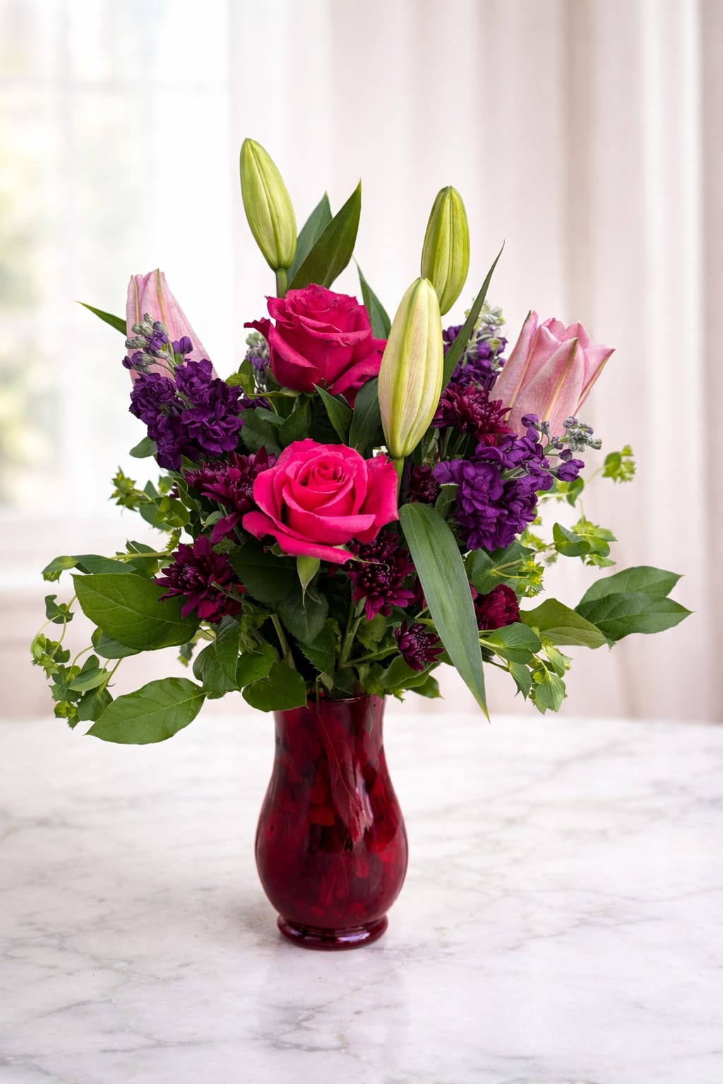 Blush Elegance Rose &amp; Lily Vase Arrangement  - Celebrate life’s special moments with our Blush Elegance Rose &amp; Lily Vase Arrangement, a beautifully handcrafted floral design featuring vibrant hot pink roses, delicate pink lilies, and rich purple accent flowers, complemented by fresh greenery.  Arranged in a modern red glass vase, this elegant bouquet is perfect for birthdays, anniversaries, celebrations, or simply brightening someone’s day. Designed by AZ Flowers &amp; Gifts in Alpharetta, GA, each arrangement is made fresh and delivered with care.