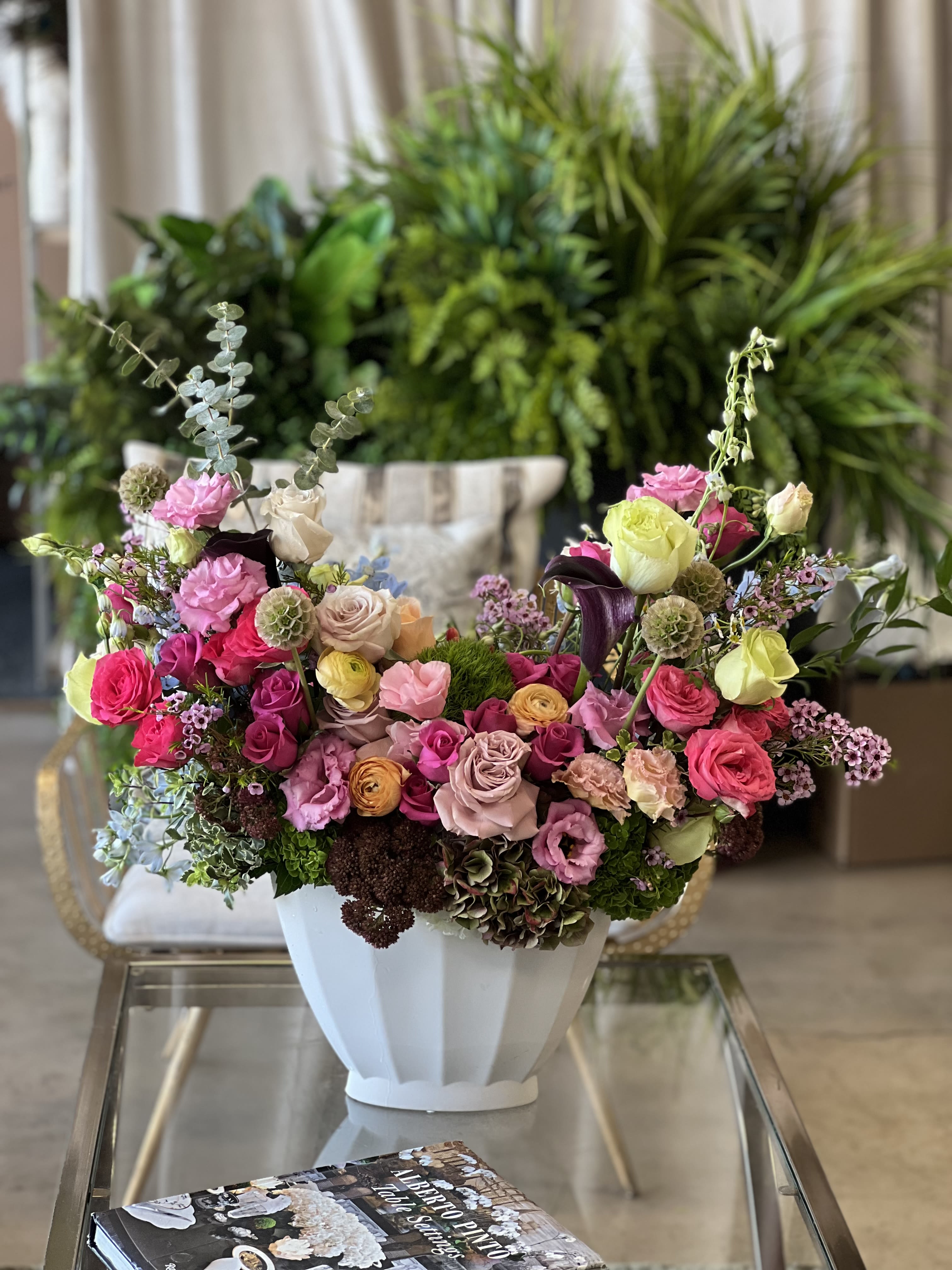 Colorful mixed flower arrangement in a white vase