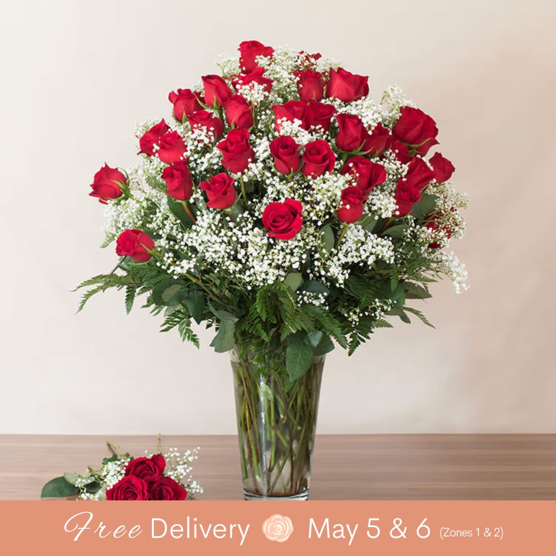 Abundant Love (The HAMMAH! with 4 Dozen Long Stem Roses)  - Introducing "The Hammah"! This amazing piece features 48 stems of premium long stem red roses elegantly arranged with accent greens in a special glass vase. Spoil the love of your life with this grand and luxurious arrangement that creates a "Drop the Mic" moment when delivered.    Key Features:    Premium Long Stem Red Roses: 48 stems of exquisite long stem red roses, symbolizing deep love and passion.    Elegant Arrangement: Expertly designed with accent greens to enhance the beauty and sophistication of the roses.    Special Glass Vase: Presented in a unique and special glass vase, adding to the grandeur and elegance of the arrangement.    Perfect for Special Occasions: Ideal for making a statement on anniversaries, Valentine's Day, or any occasion where you want to express deep love and admiration.    Luxurious Gift: Spoil your loved one with this luxurious and breathtaking floral arrangement that promises to leave a lasting impression.    Give "The Hammah" and create a memorable "Drop the Mic" moment with this stunning display of 48 premium long stem red roses, designed to convey your love and affection in the most grand and elegant manner.