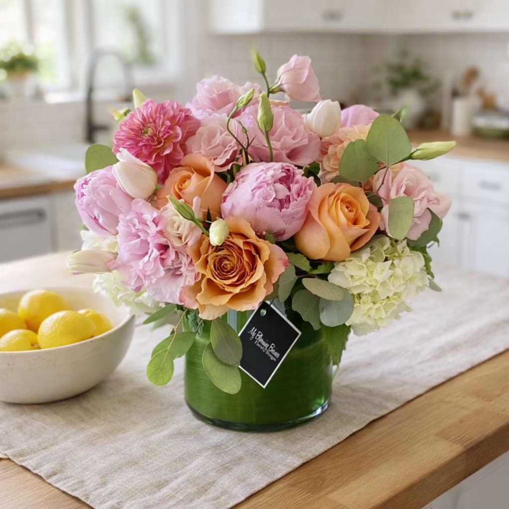 Luna Arrangement – A Soft Blush of Beauty - Luna Arrangement – A Soft Blush of Beauty The Luna Arrangement by My Blooming Business is an elegant floral design that blends romance and freshness in a beautifully crafted 5x6 clear cylinder vase, lined with a glossy tea leaf wrap for a refined touch. This lush arrangement features seasonal favorites like pink peonies, roses, spray roses, tulips, dahlias, and hydrangeas, all in soft, feminine tones.  Perfect for celebrations, anniversaries, or as a charming gesture “just because,” the Luna is a timeless favorite.  As a top-rated florist in Los Angeles on Google, Yelp, and BloomNation, My Blooming Business offers reliable flower delivery across the greater Los Angeles area, including the San Fernando Valley and San Gabriel Valley.  PLEASE NOTE: When peonies are out of season, they are thoughtfully replaced with premium garden roses to maintain its luxurious feel. 