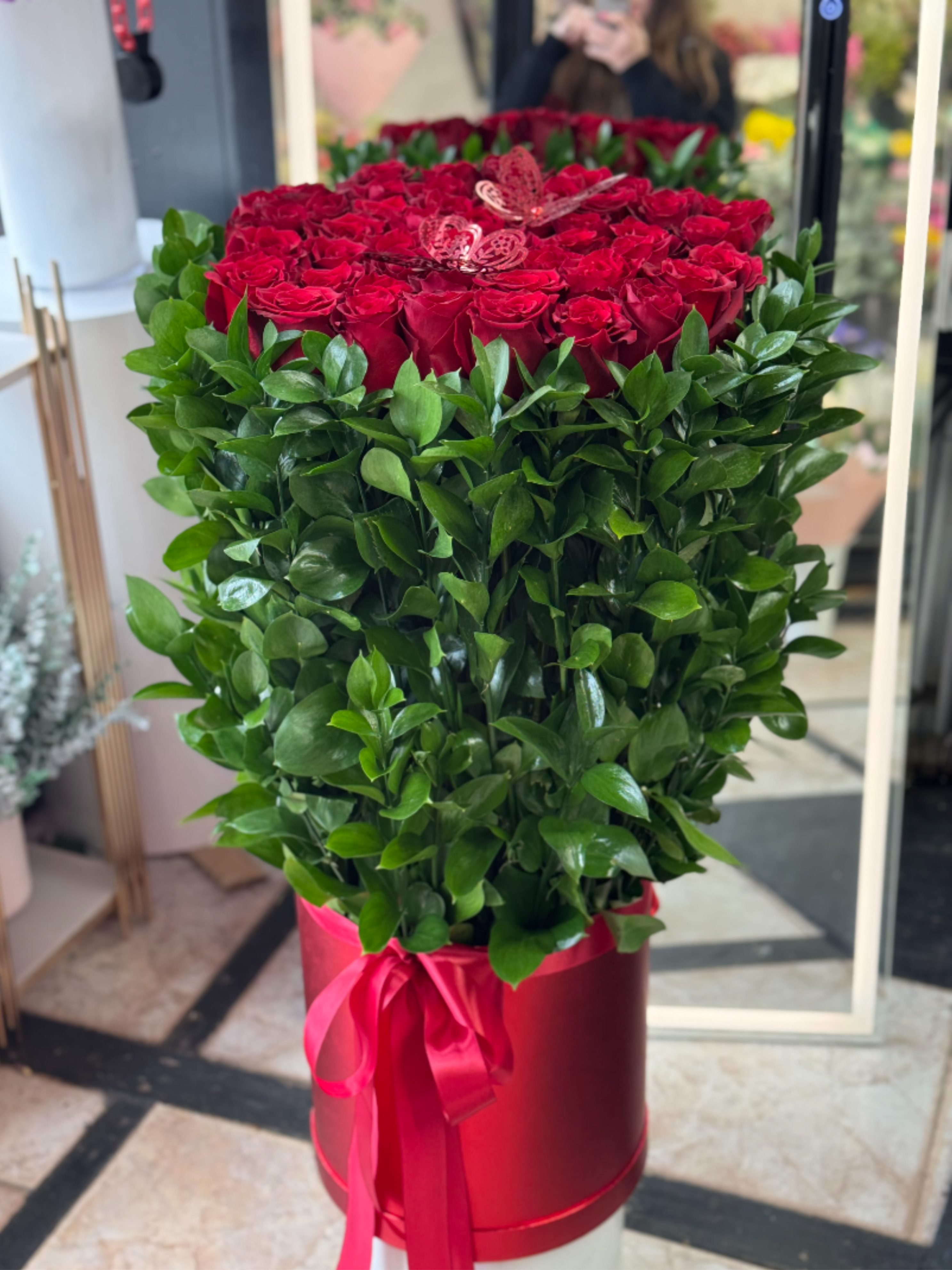 Long Red Roses in a Box.       The photo shows the deluxe size. - The photo shows the deluxe size. Standard size 50 Roses. Deluxe 75 Roses.