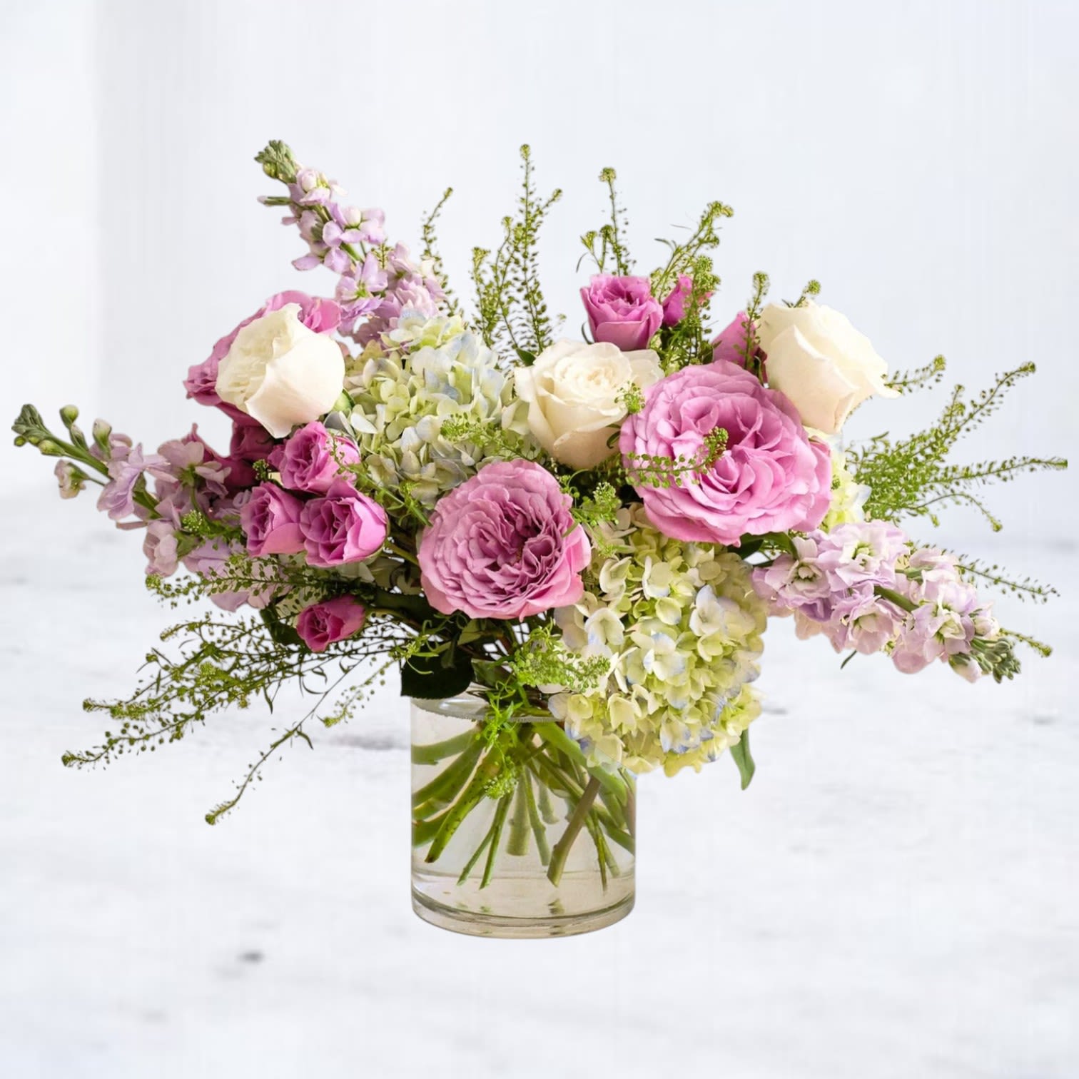 Rosy Outlook - Fresh, romantic, and full of natural movement, Rosy Outlook blends soft pink roses with creamy hydrangea and delicate seasonal blooms for a lush, garden-inspired design. Accented with airy greenery and layered texture, this arrangement offers a balanced mix of fullness and softness. Arranged in a clear glass vase, it’s a perfect choice for birthdays, celebrations, get well wishes, or sending something beautiful and uplifting.  Whiskey Wallflower is a design-forward florist based in Magnolia, offering same-day flower delivery throughout Magnolia, Montgomery, The Woodlands, Conroe, Tomball, Willis, Spring, and surrounding North Houston communities. Each arrangement is thoughtfully composed using premium blooms, with a focus on modern design, quality, and intentional detail.