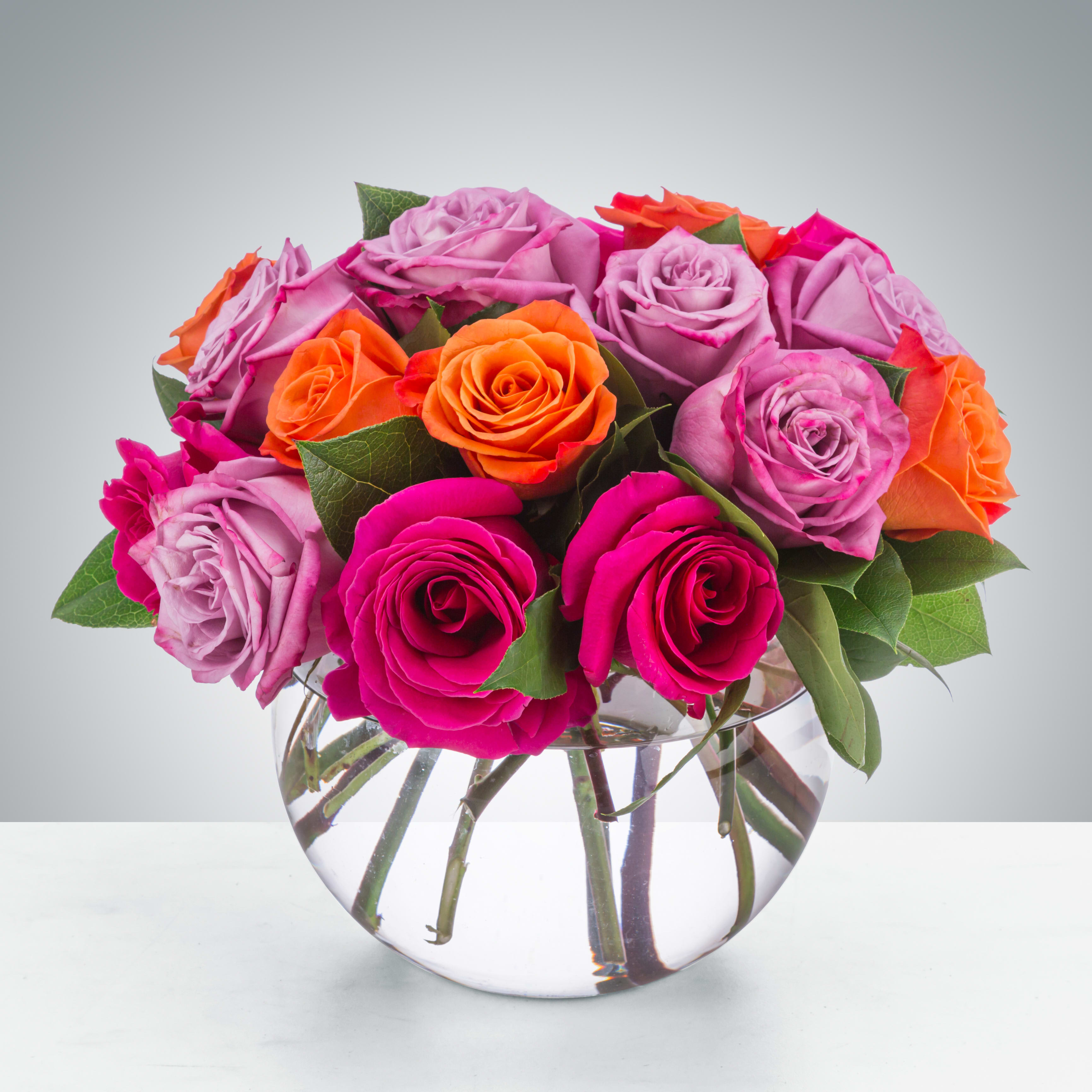 Daybreak by BloomNation™ - A lovely bowl of colorful roses brightens and lifts any room (and relationship!) A great gift for sending on Valentine's Day to your significant other, your friend, or even your mom!  Approximate Dimensions: 11''D x 11''H 18 roses arranged in a 6 inch clear bubble bowl.