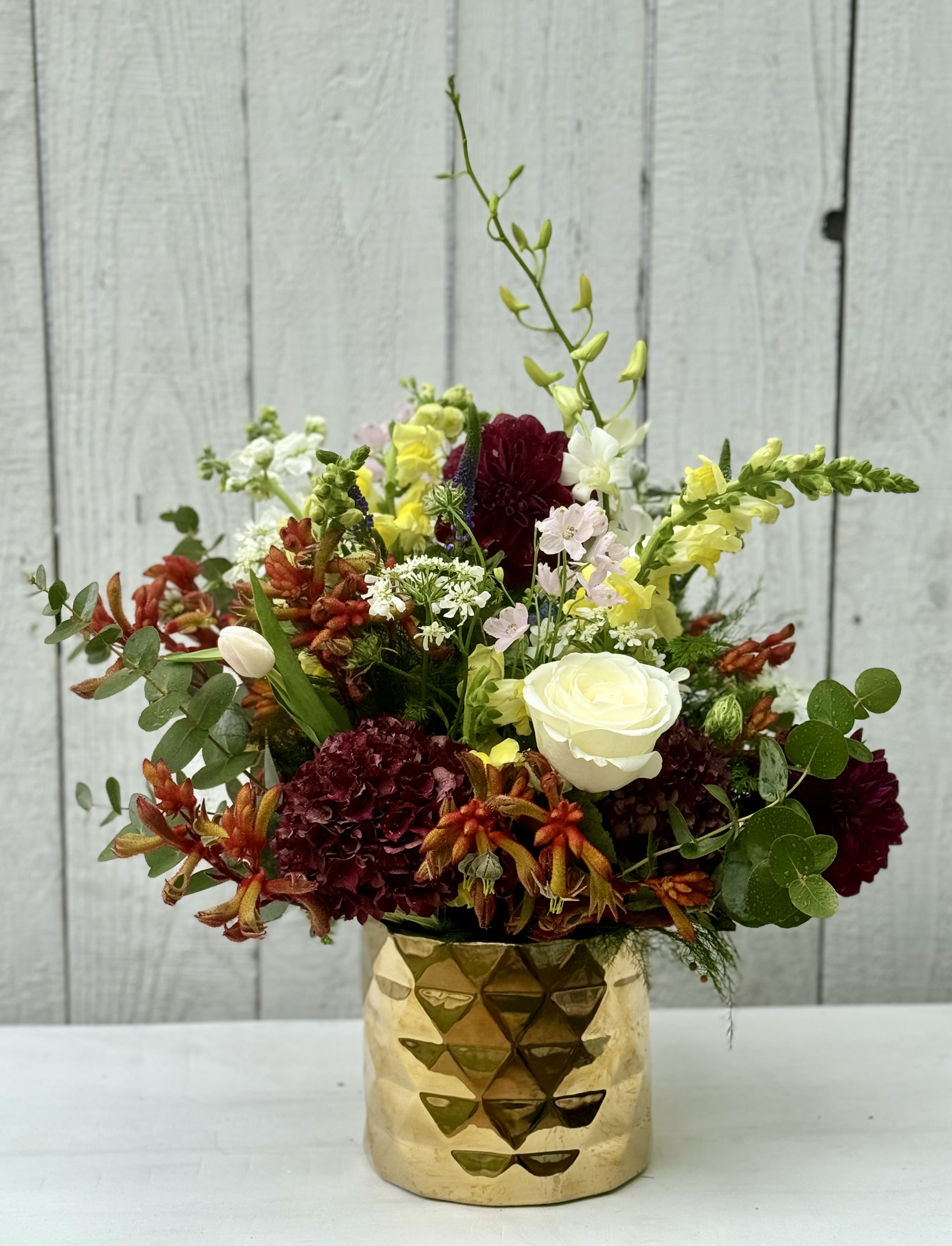 JOSHUA TREE - A gorgeous arrangement with all the colors of the desert. The dahlias, alongside Monkey Paw, snapdragons, orchids and special green touches make this design unique and beautiful!